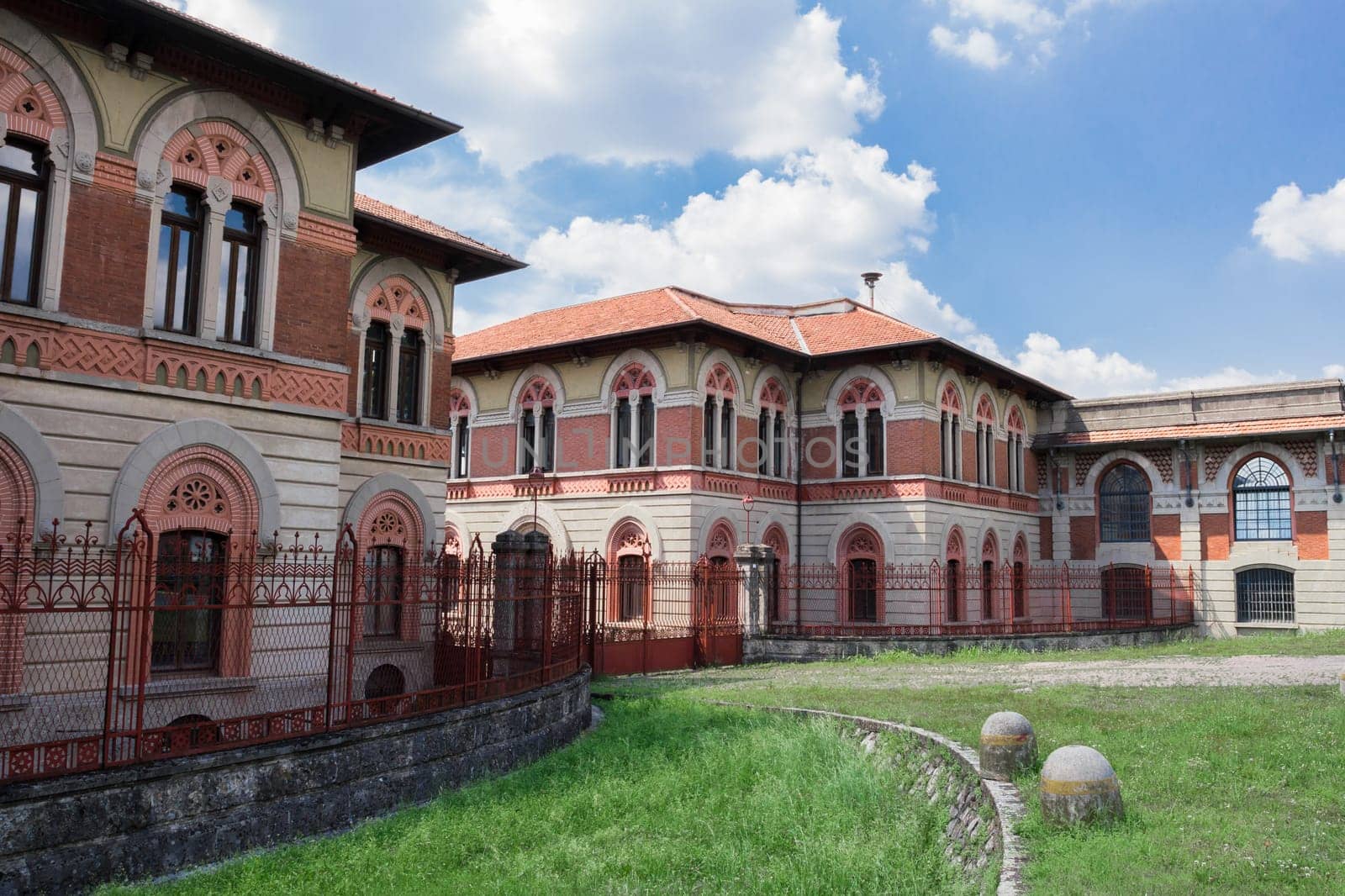 Entrance to the factory of Crespi d'Adda. The entrance is characterized by the so-called "red gates"" in wrought iron."