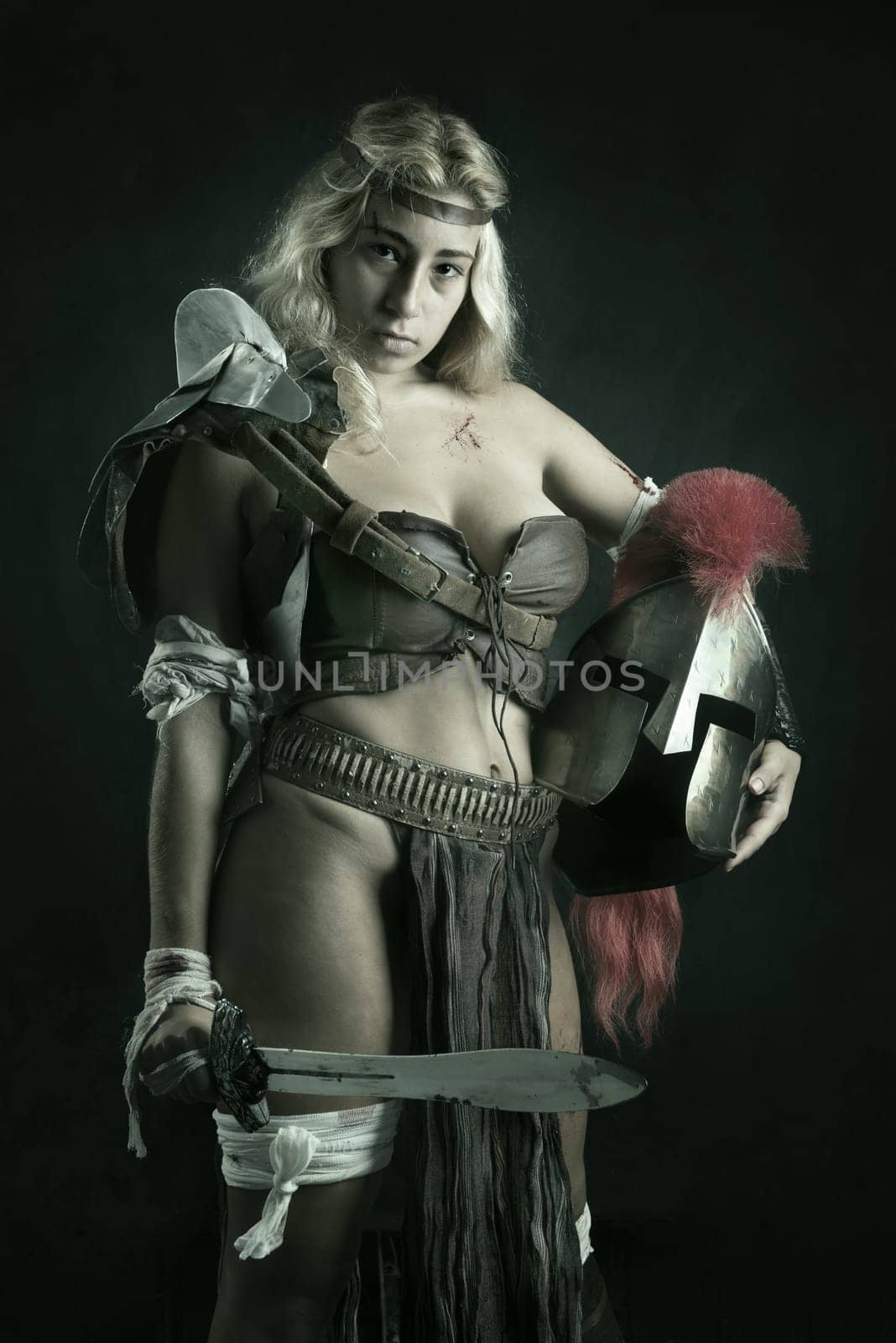Ancient woman warrior or Gladiator posing in a dark background