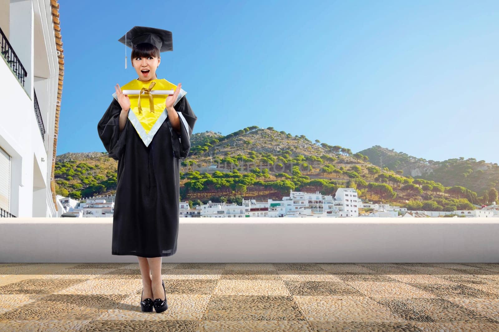 Happy asian student girl holding diploma scroll at graduation ceremony