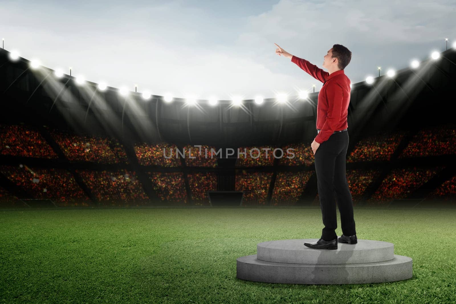 Attractive asian businessman standing and pointing to the sky on podium