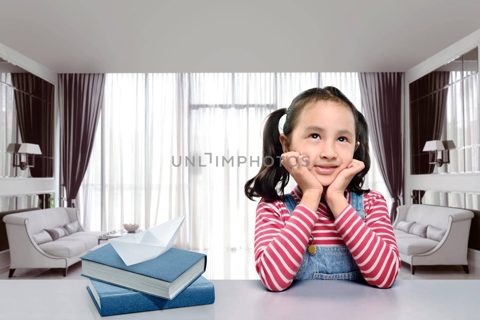Smiling asian girl with book imagine something at home