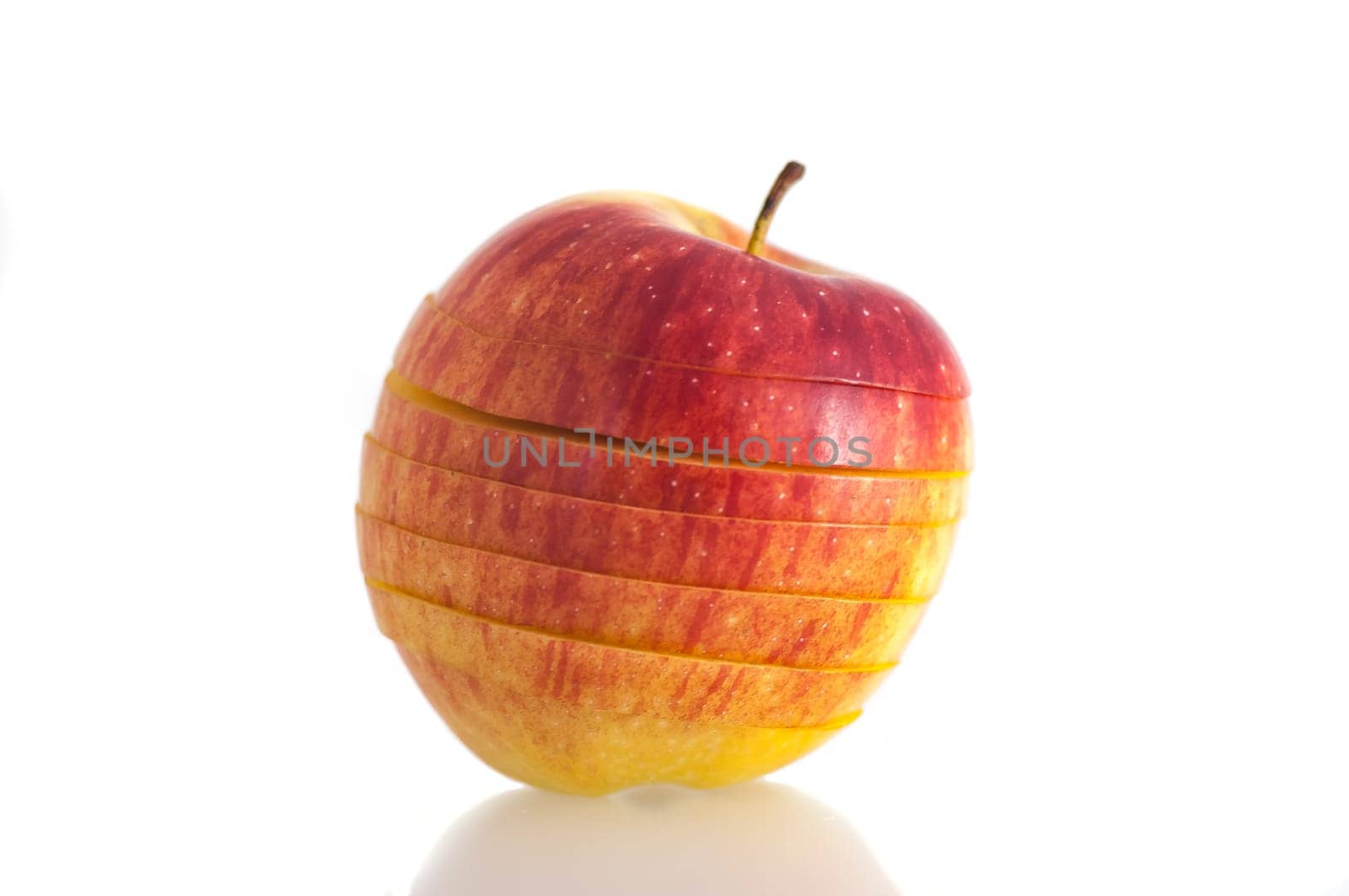 isolated on white background isolated closeup red bright, juicy fresh apple sliced into slices.