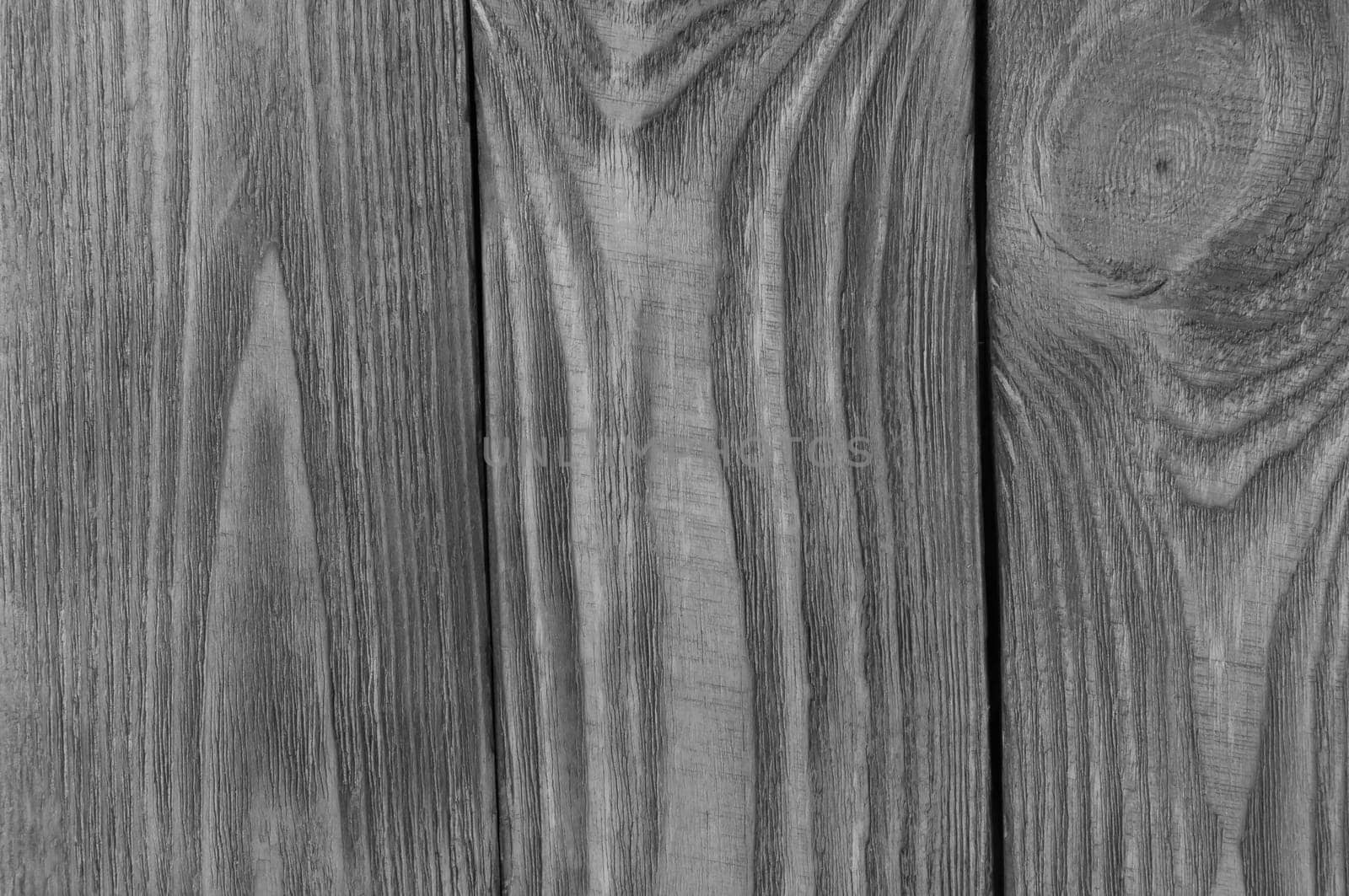 Monochrome background of wooden boards arranged vertically.