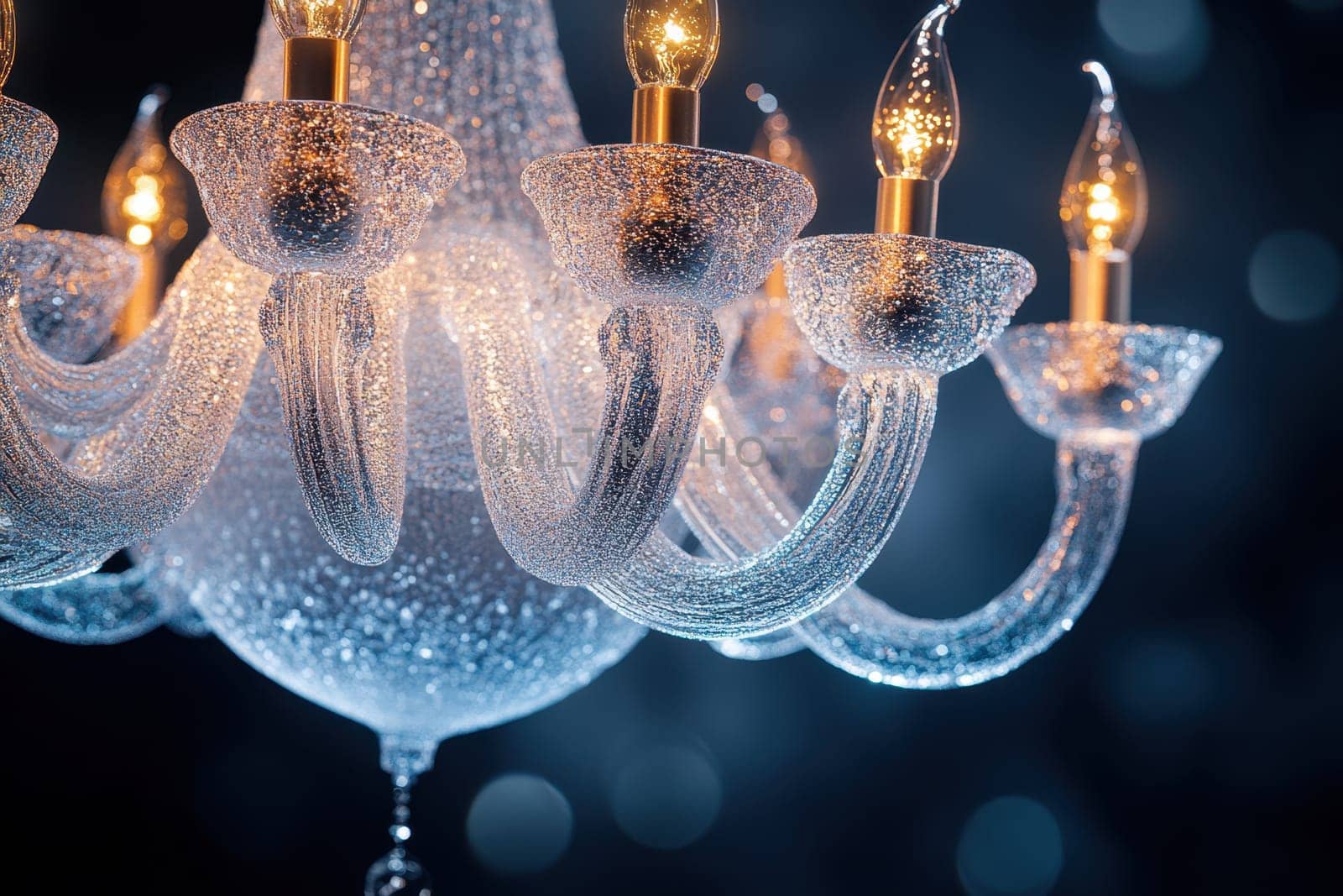 A stunning chandelier features intricate design elements with clear crystals and glowing lights. Its warm illumination enhances the luxurious atmosphere of the dimly lit space, captivating all who enter.