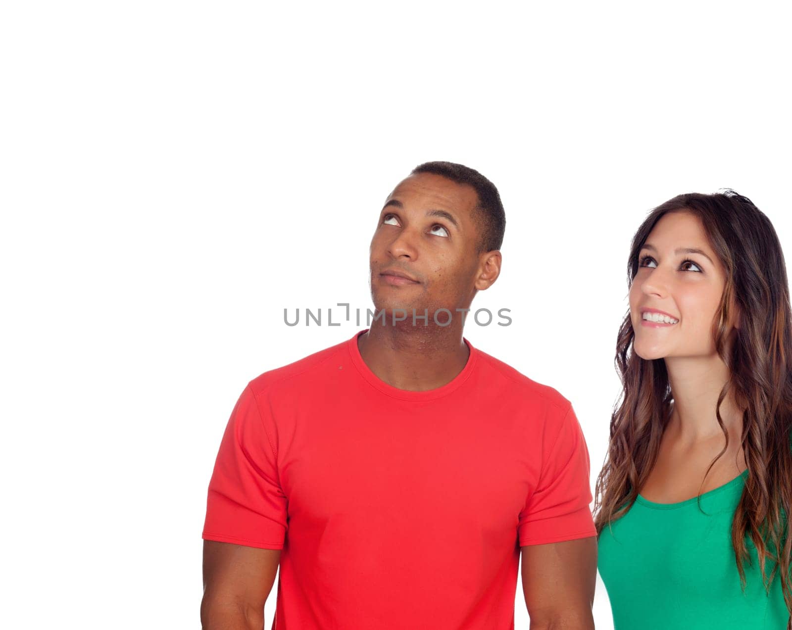 Handsome african guy and his caucasian girl looking up isolated on a white background