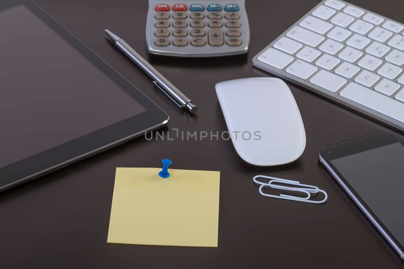 Office desk with digital tablet smartphone keyboard and mouse. Business workspace concept with blank paper for your text.