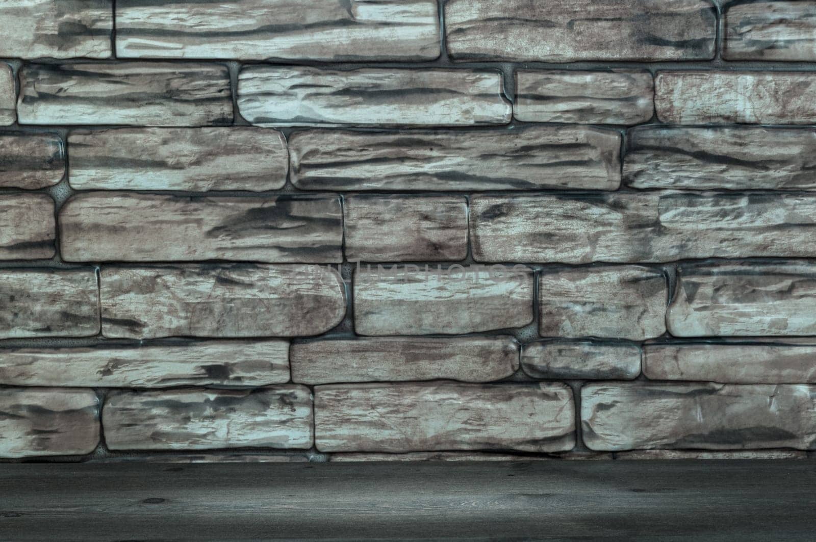 The wall is made of bricks and wooden boards with a spot of illumination.