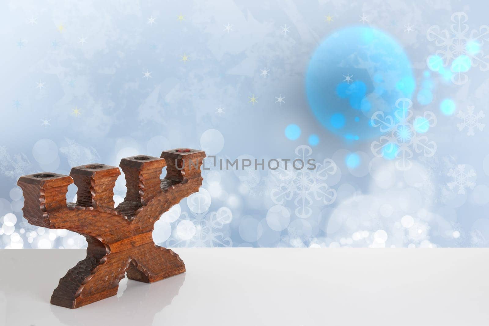 Template winter background.  An old wooden candle holder on a bright table with space on right site in front of beautiful abstract winter landscape. Template for your product display montage.