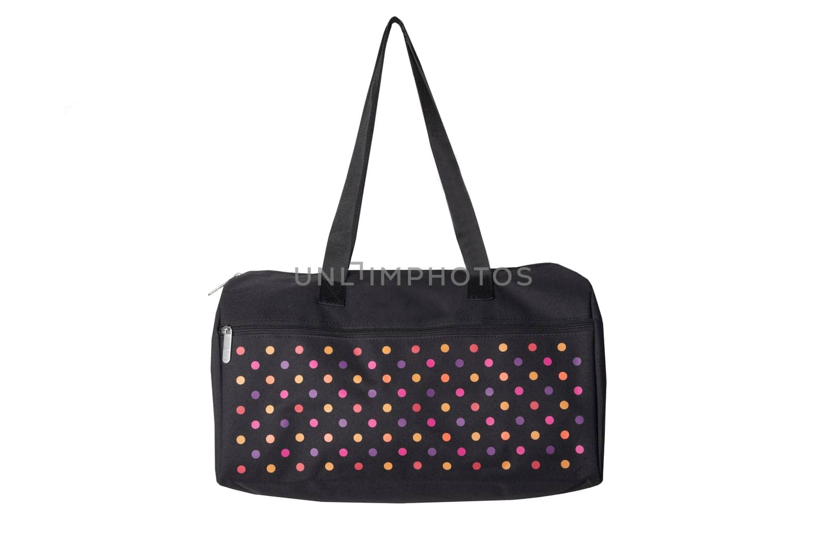 Bags fashion. Closeup of multicolored dotted overnight bag on a white background. Travel concept.