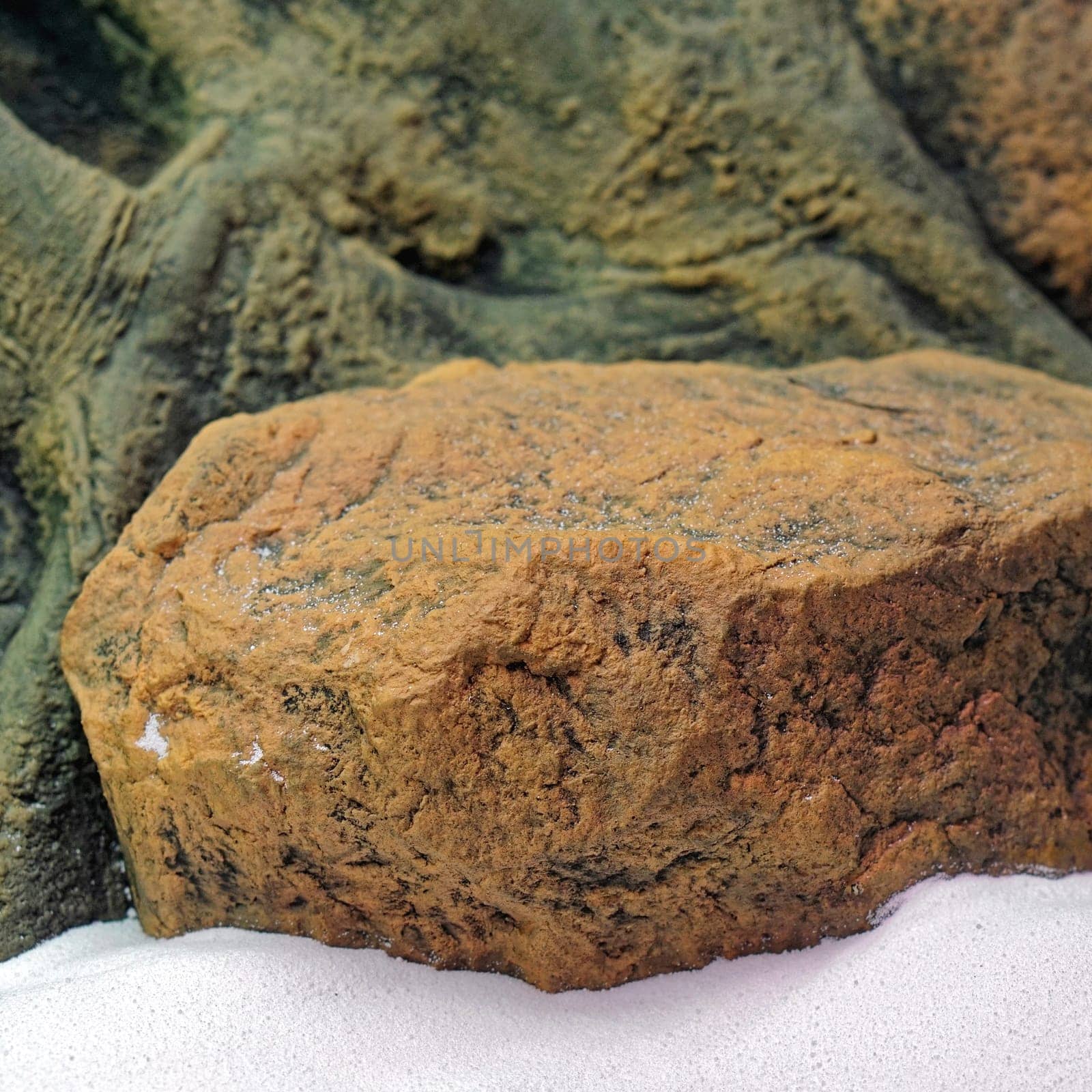 Underwater stone in aquarium with sand
