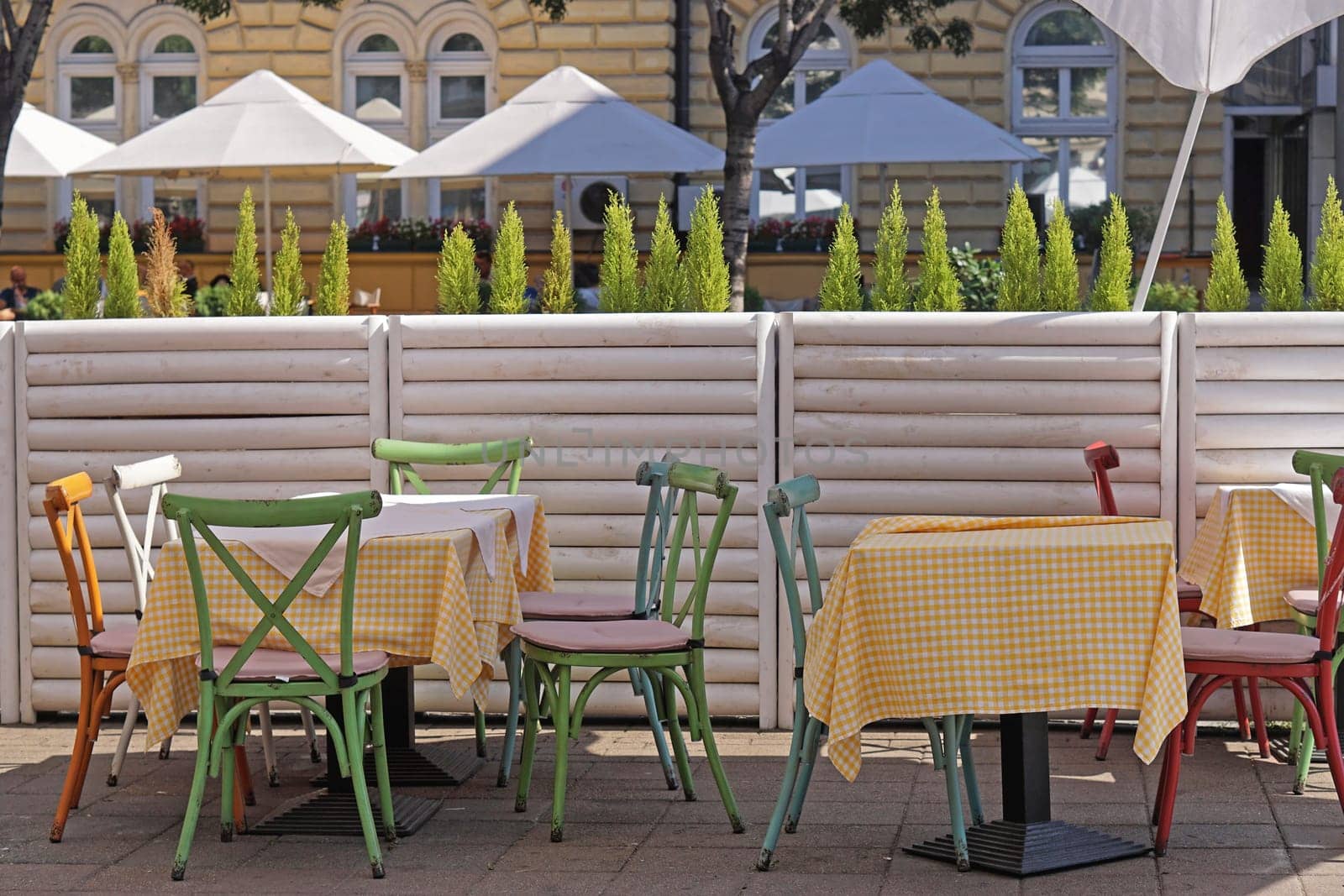 Cafe tables and chairs at city street outdoor