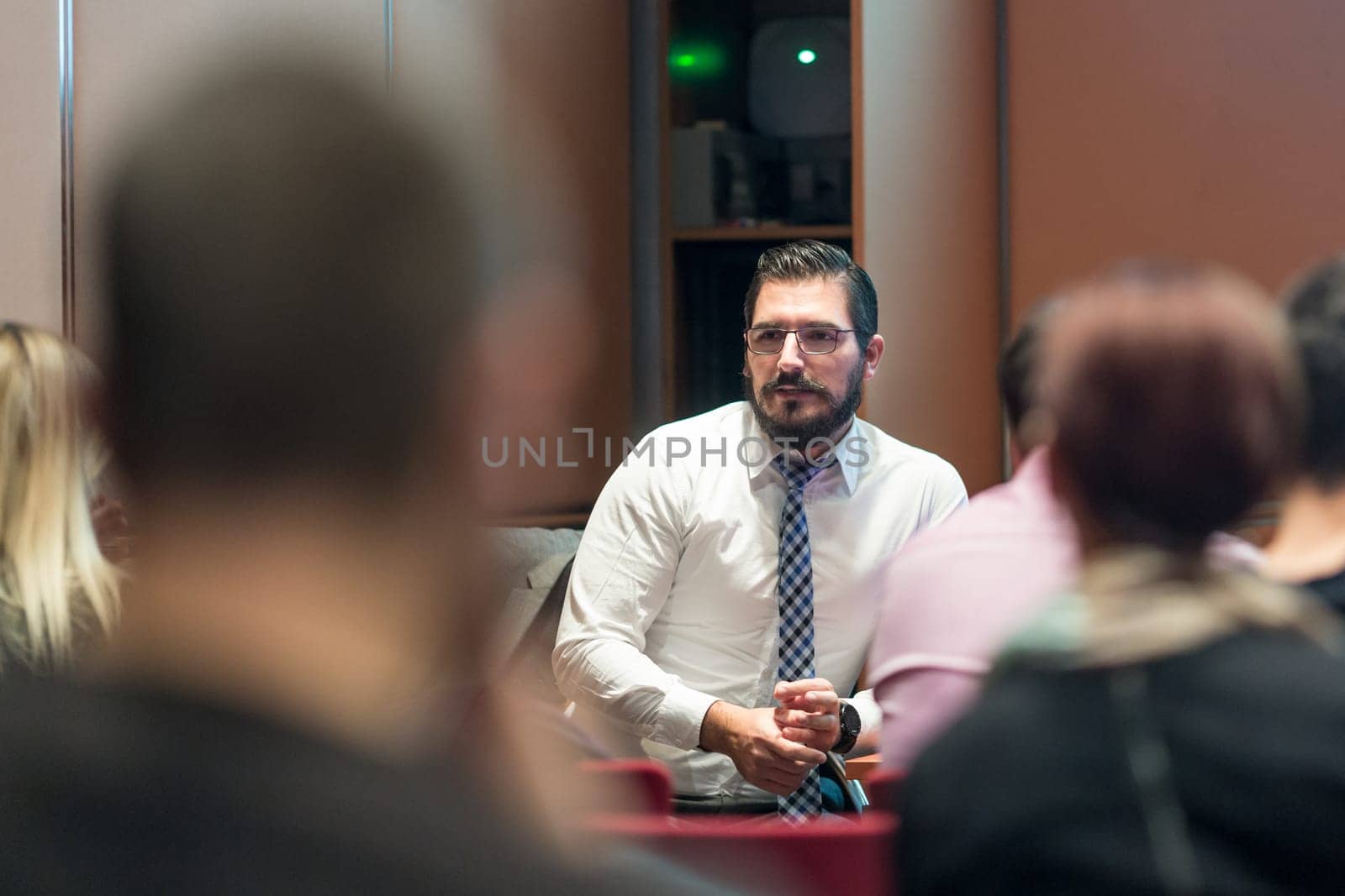 Speaker Giving a Talk at Business Meeting. Audience in the conference hall. Business and Entrepreneurship concept.