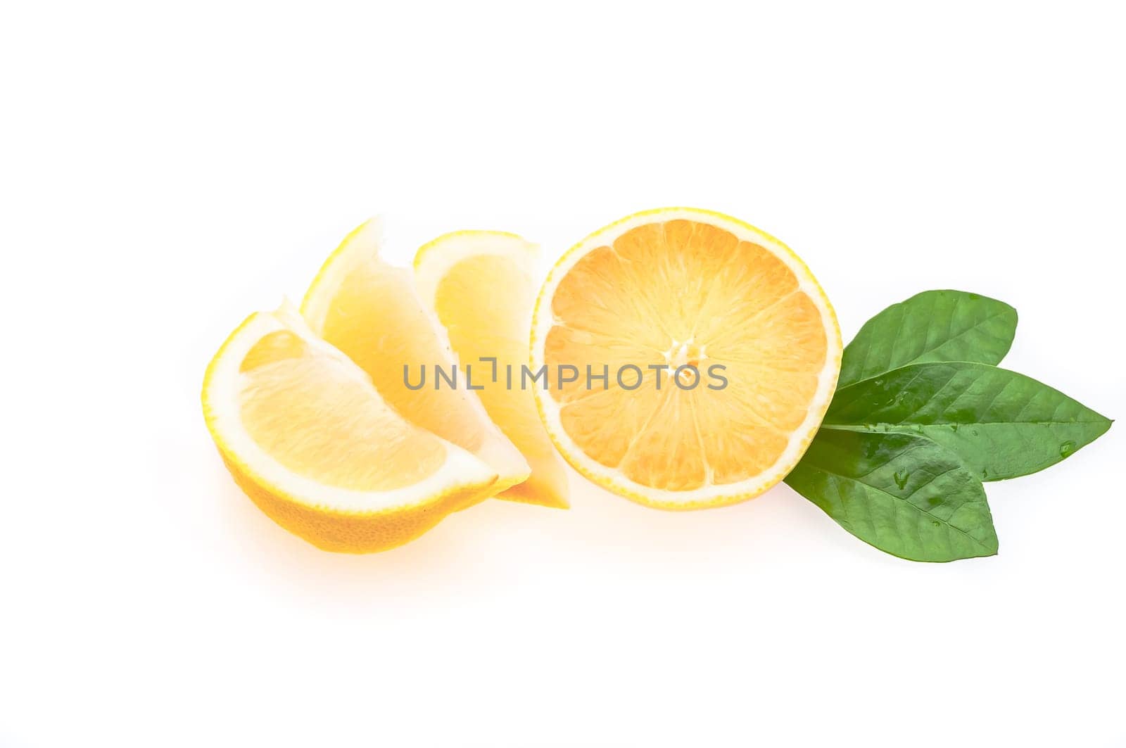Half a fresh, glowing lemon with green leaves and several cut slices on a white background. isolated.