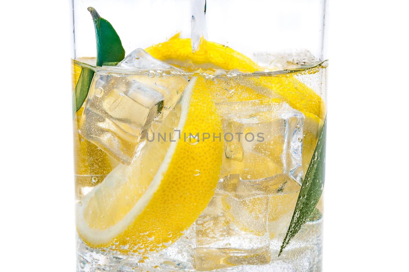 In the jug is a drink of ice, the lobules of a fresh juicy lemon and crystal clear water.