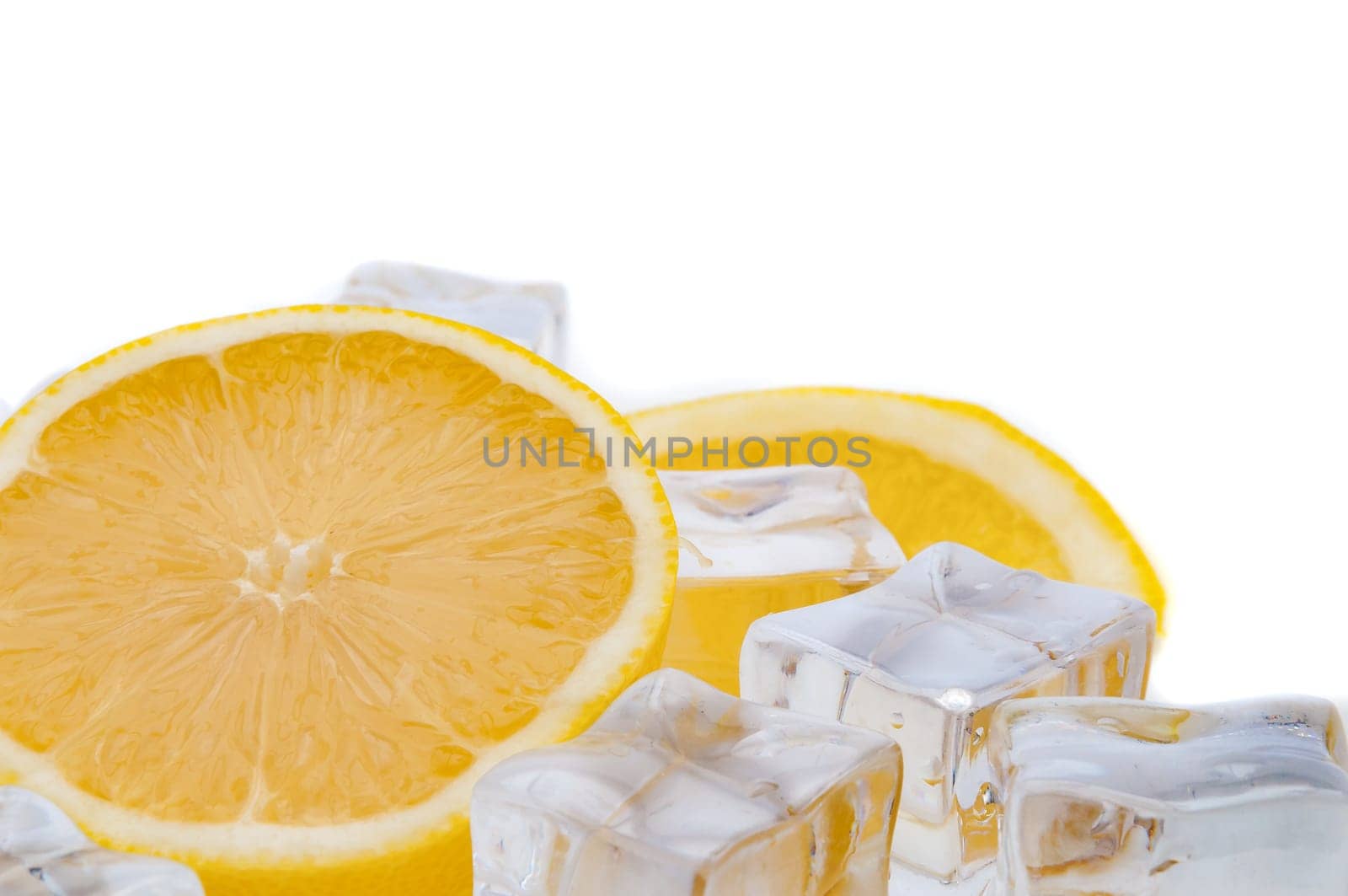 Half a juicy bright lemon and refreshing ice cubes close-up