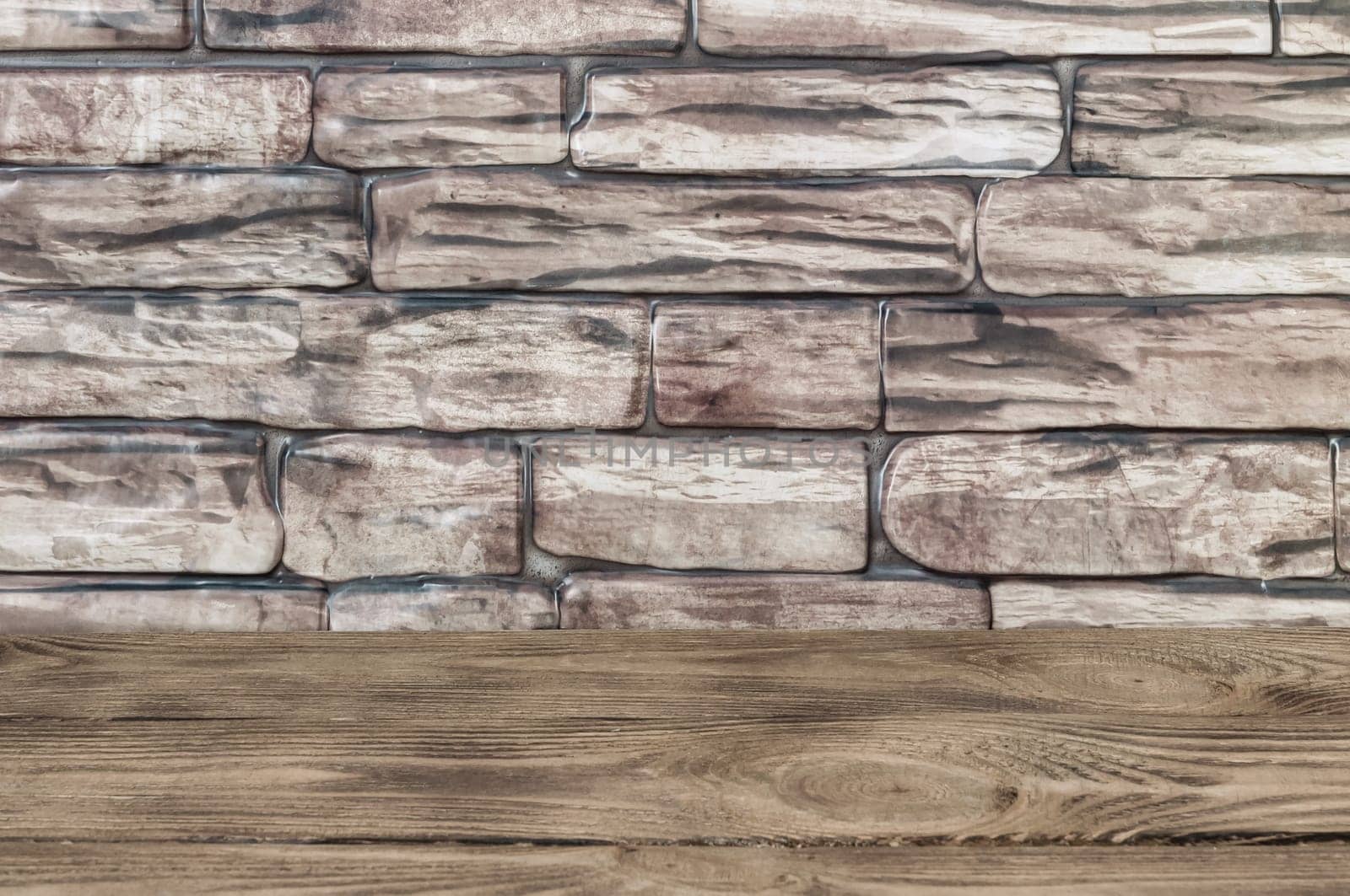 The background is a wall of brown bricks and wooden boards.