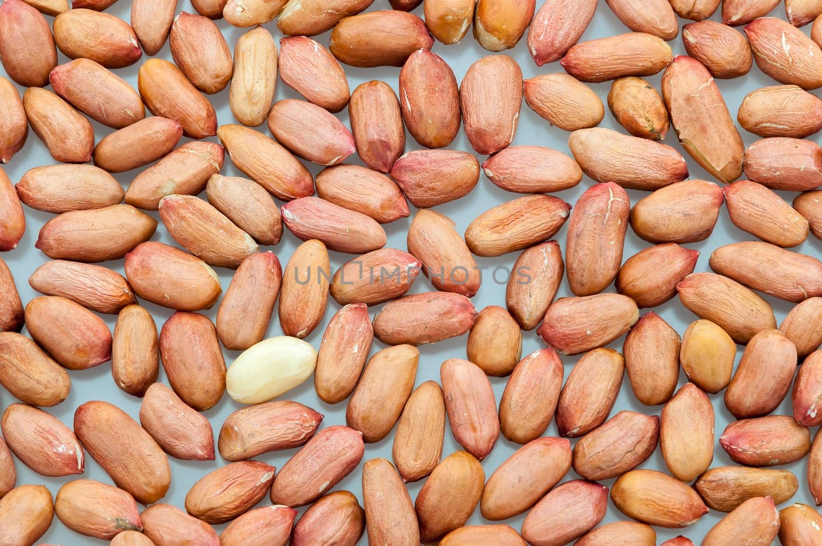 Background of peeled peanuts on a white table close-up