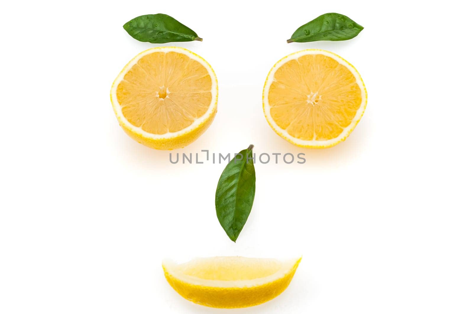 Lemon slices and green leaves in the form of a face. The concept of a healthy lifestyle.
