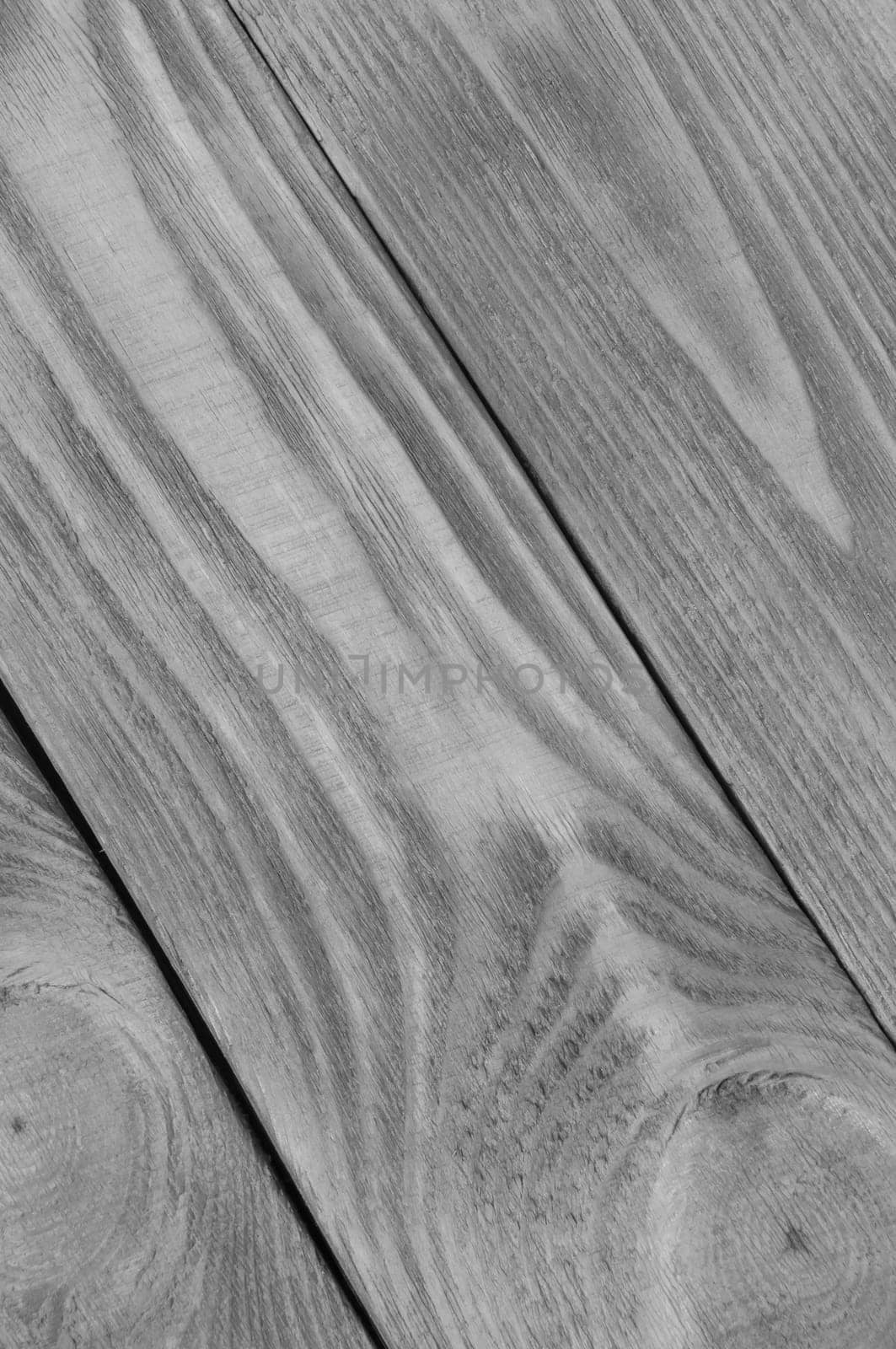 Black and white background from boards of light wood arranged diagonally