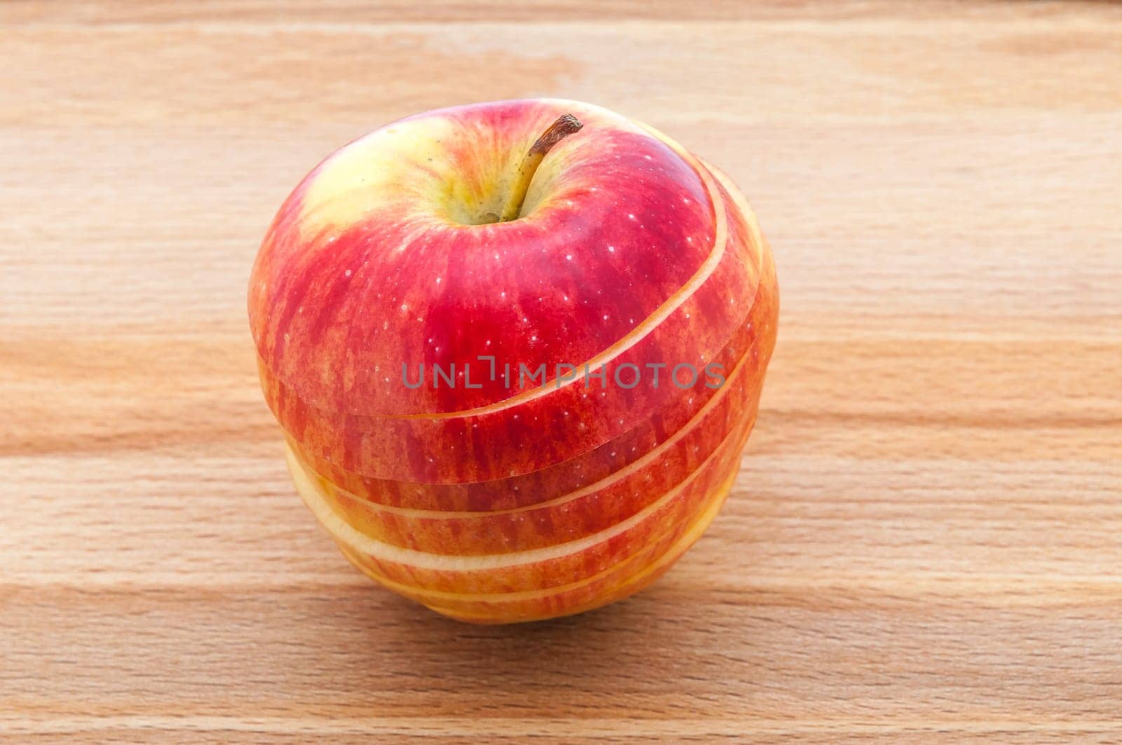 Red apple close-ups cut by mugs on a cutting board