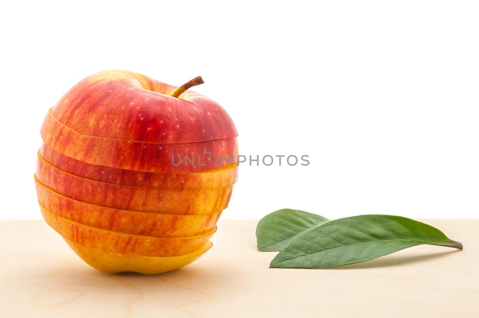 apple preserved its shape, but cut into slices on a wooden table.