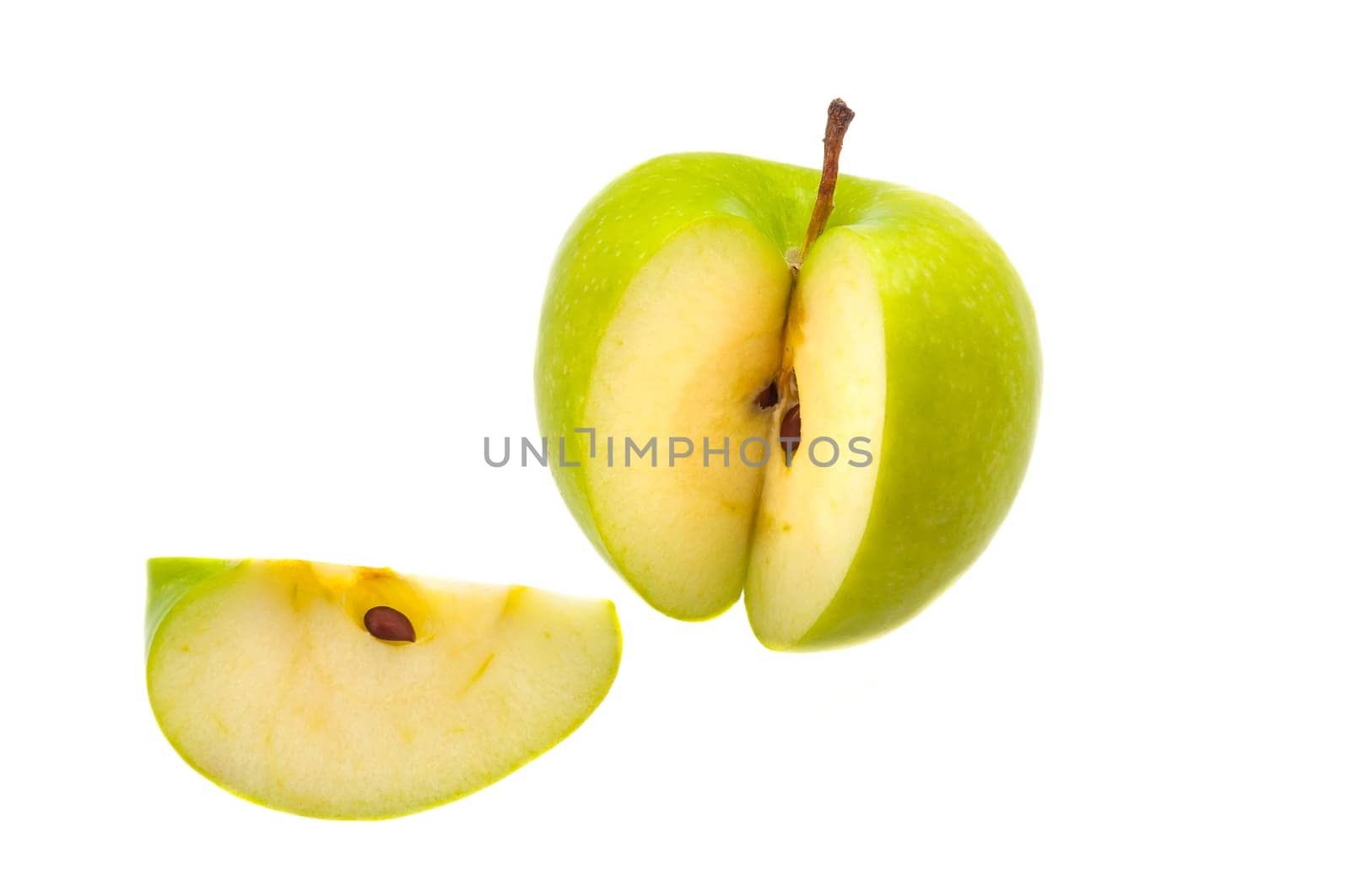 Slice is cut off from a large fresh green apple.