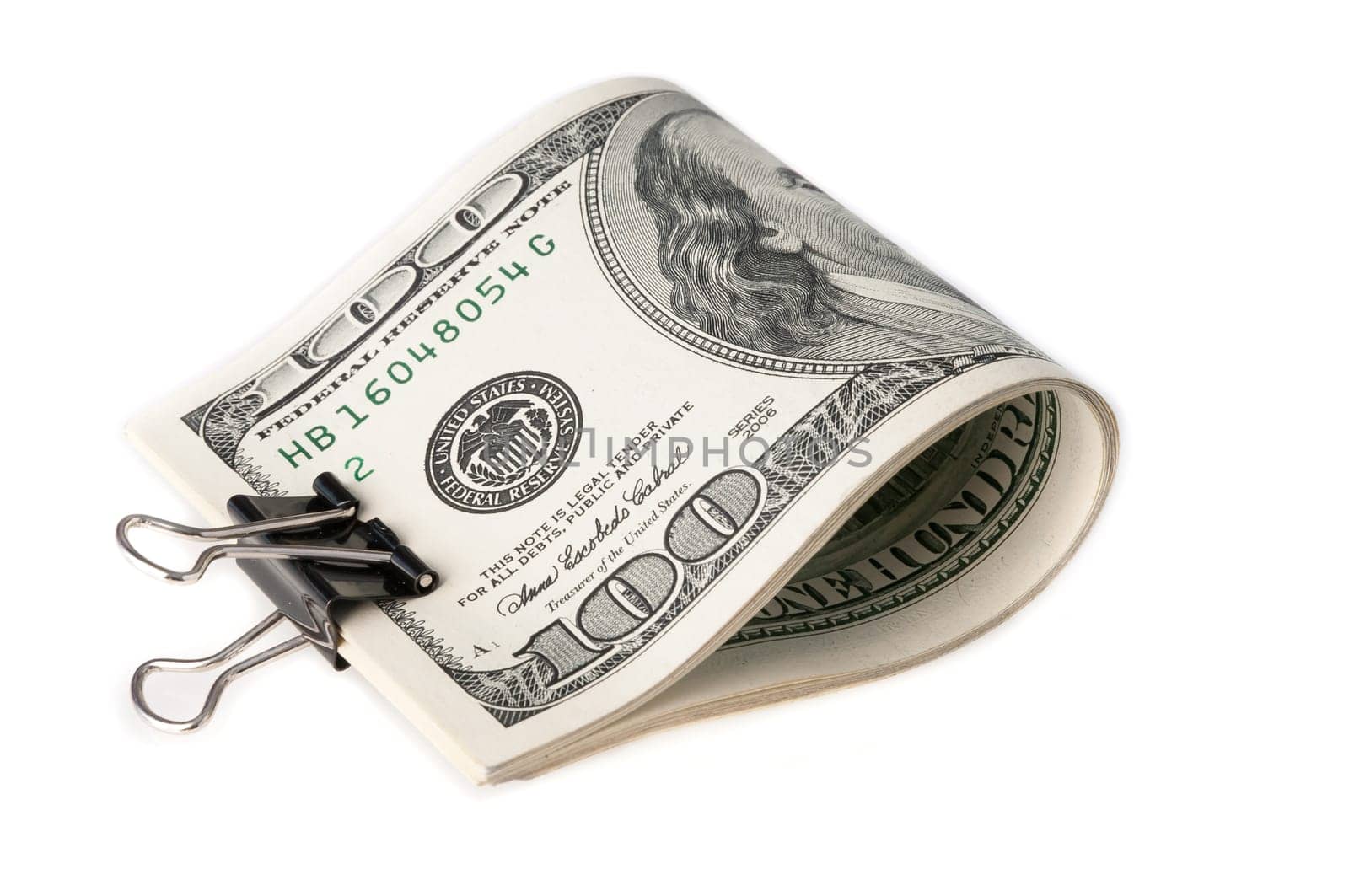 The American dollar bills are folded and clamped with a paper clip. on white background.