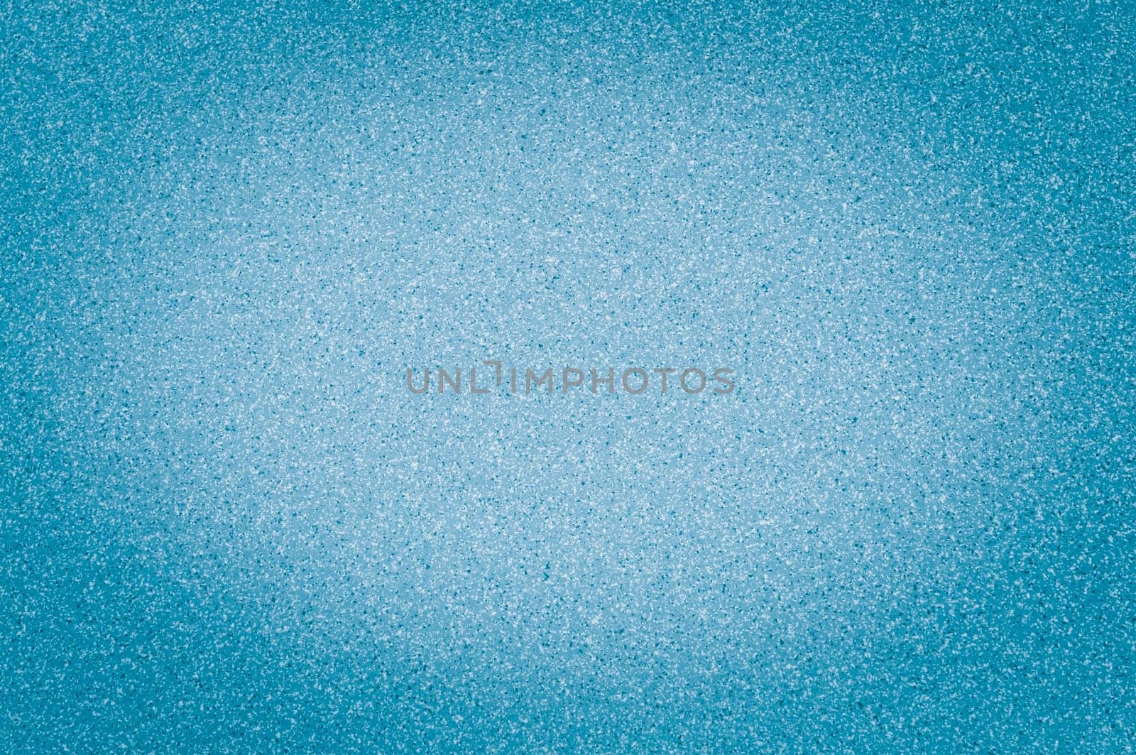 Texture of granite light blue color with small dots, with vignetting.