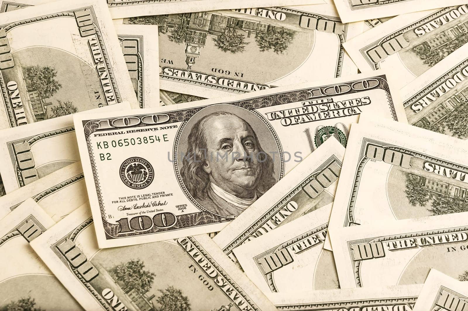 A background of one hundred dollar bills in a vintage style.
