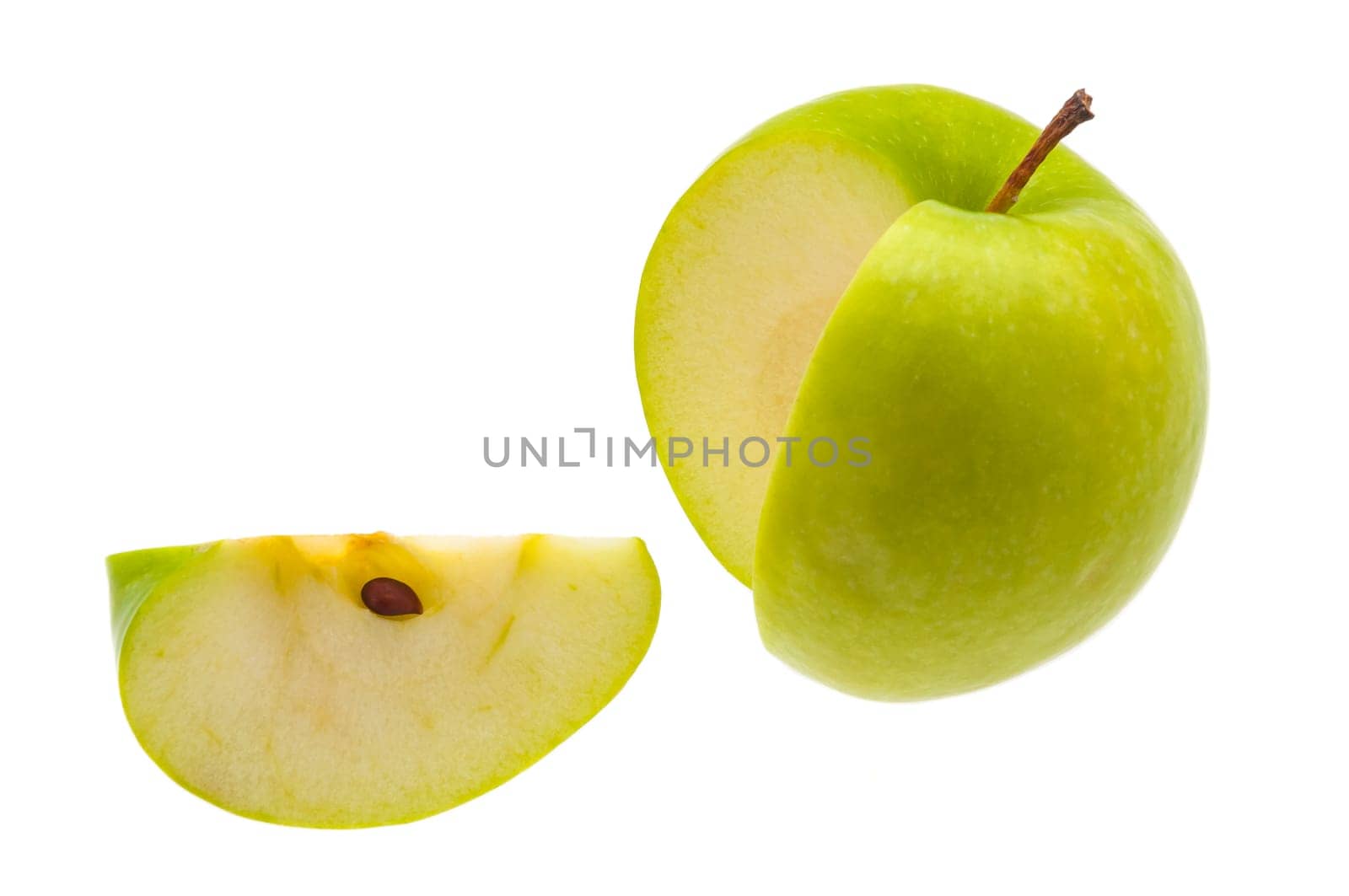 Slice is cut from a large fresh green apple on a white background.