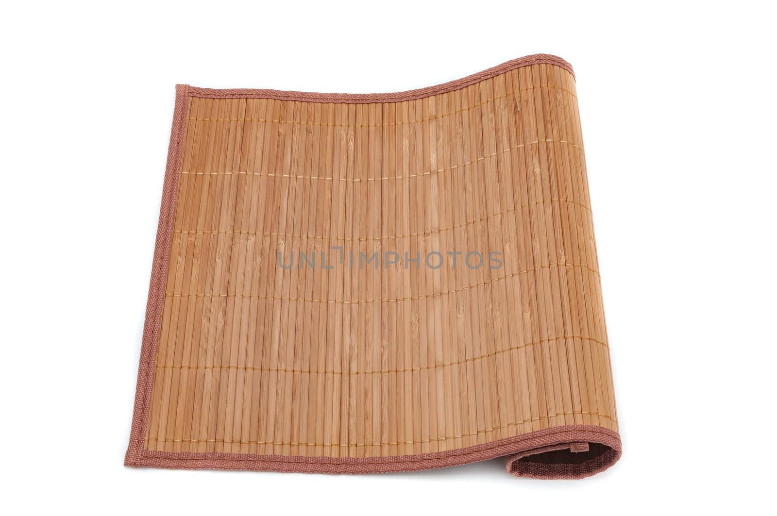 A bamboo mat on a white background is tucked on one side. Isolated.