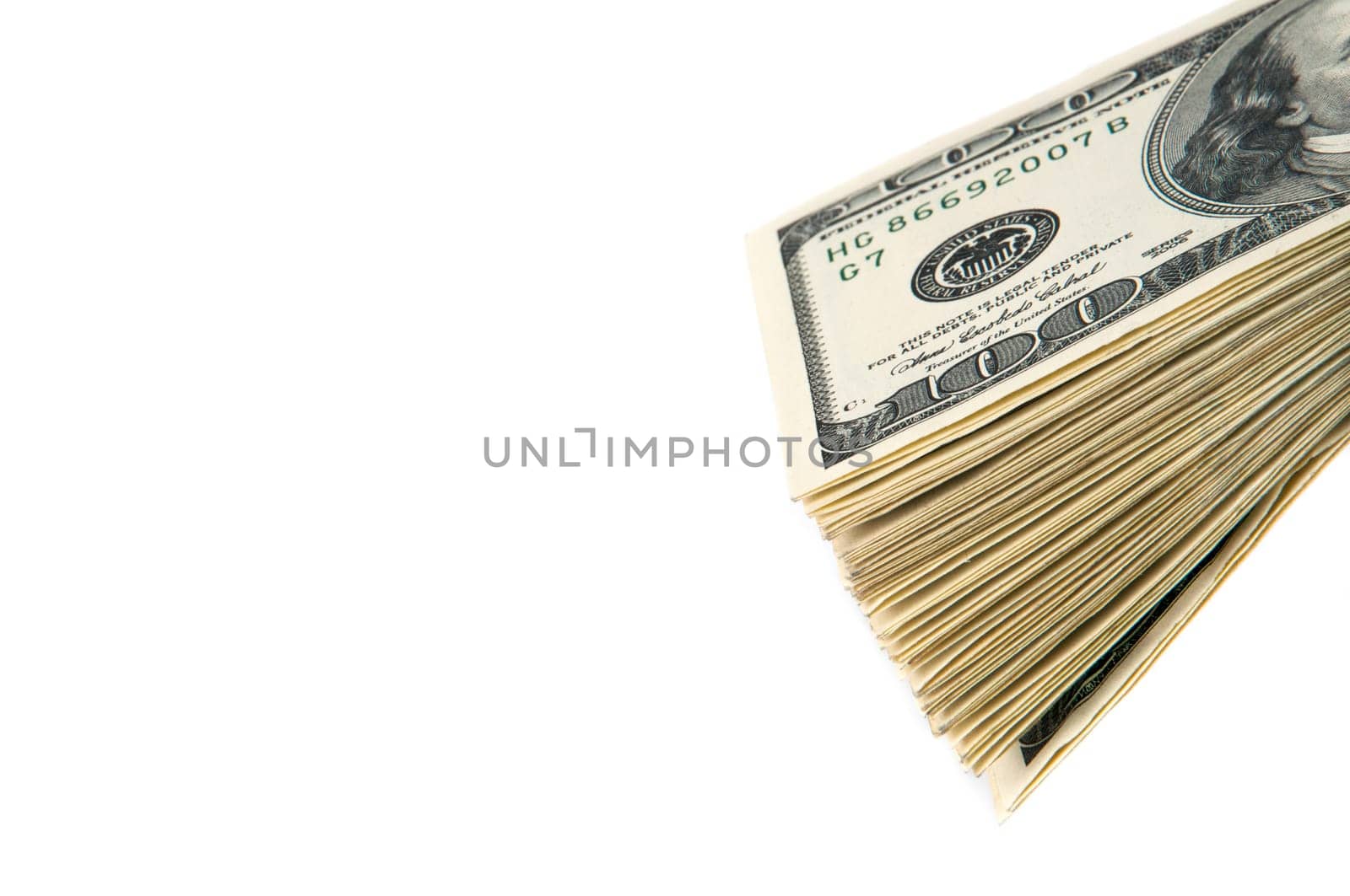 A stack of one hundred dollar bills on a white background. Isolated.