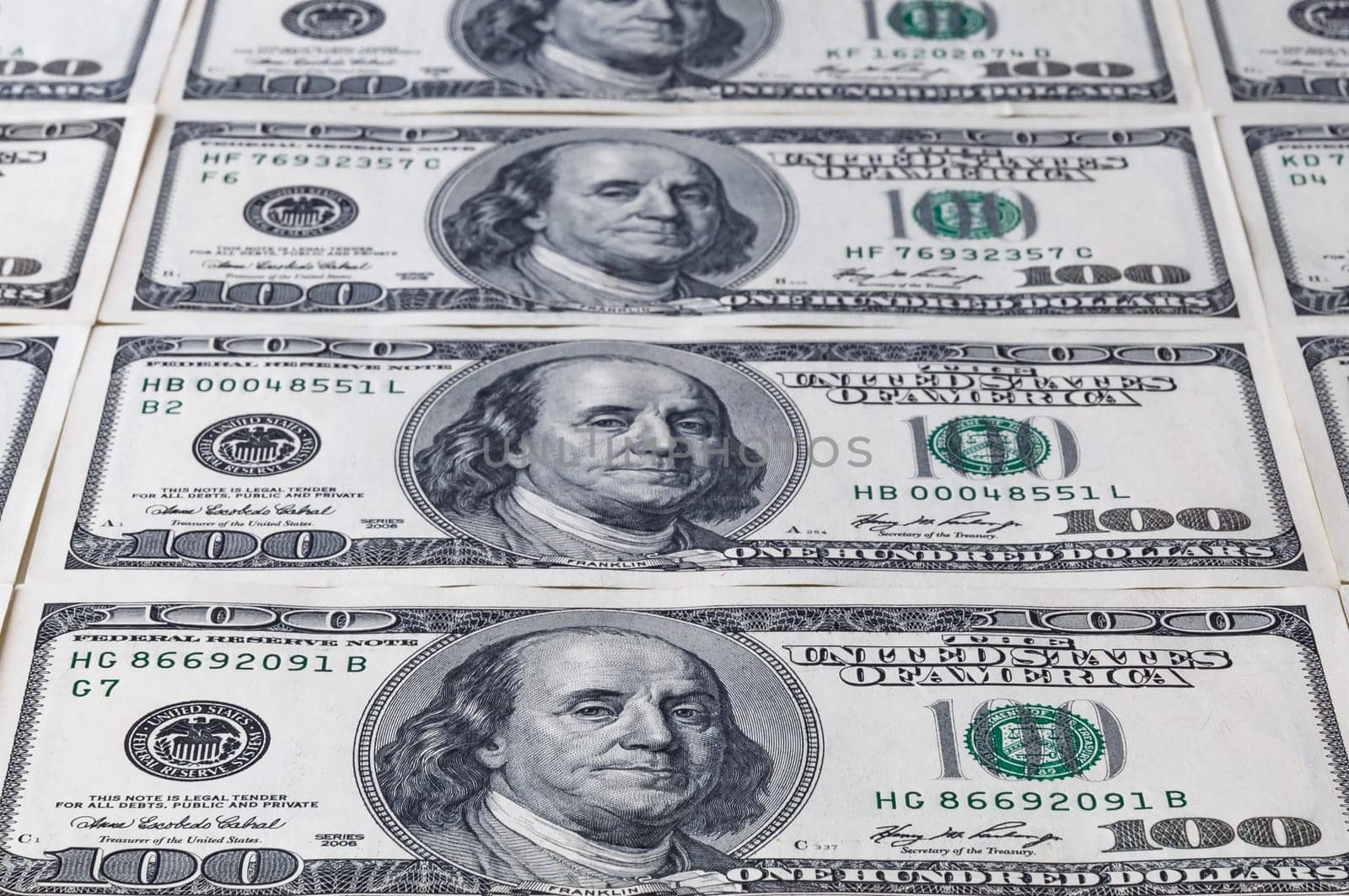 Denominations on hundred dollars a sheet stretching into the distance. Background of dollars.