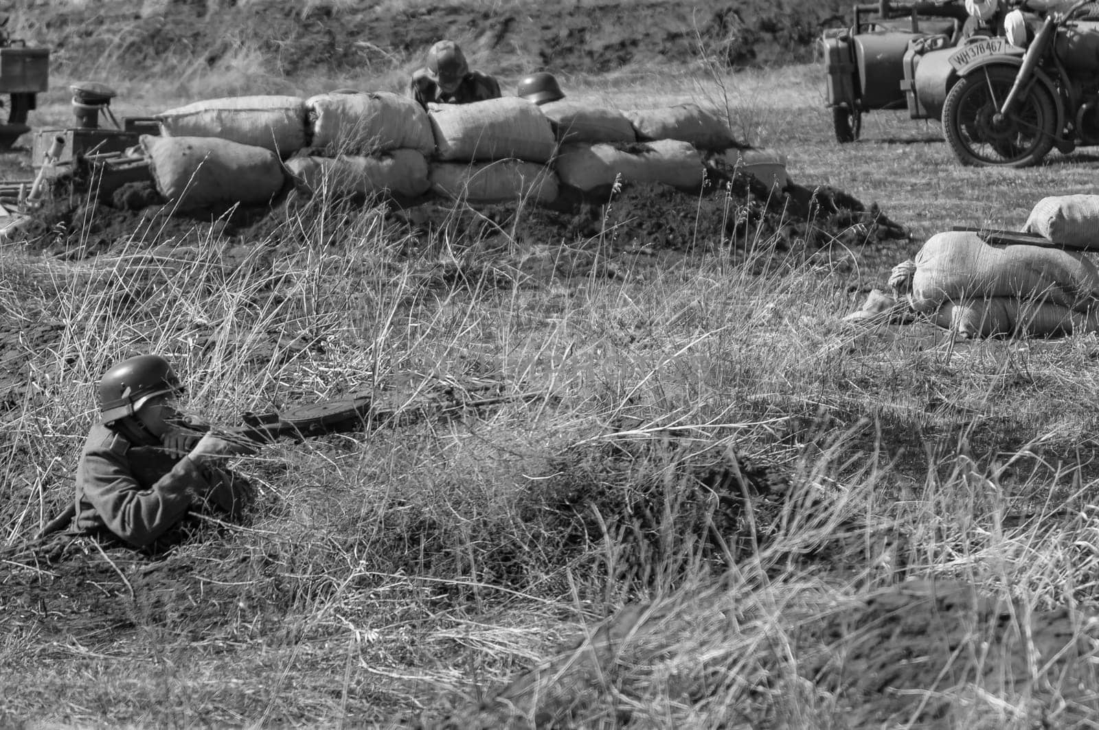 A German soldier shoots at soldiers of Soviet troops. Reconstruction of hostilities 2018-04-30 Samara, Russia.