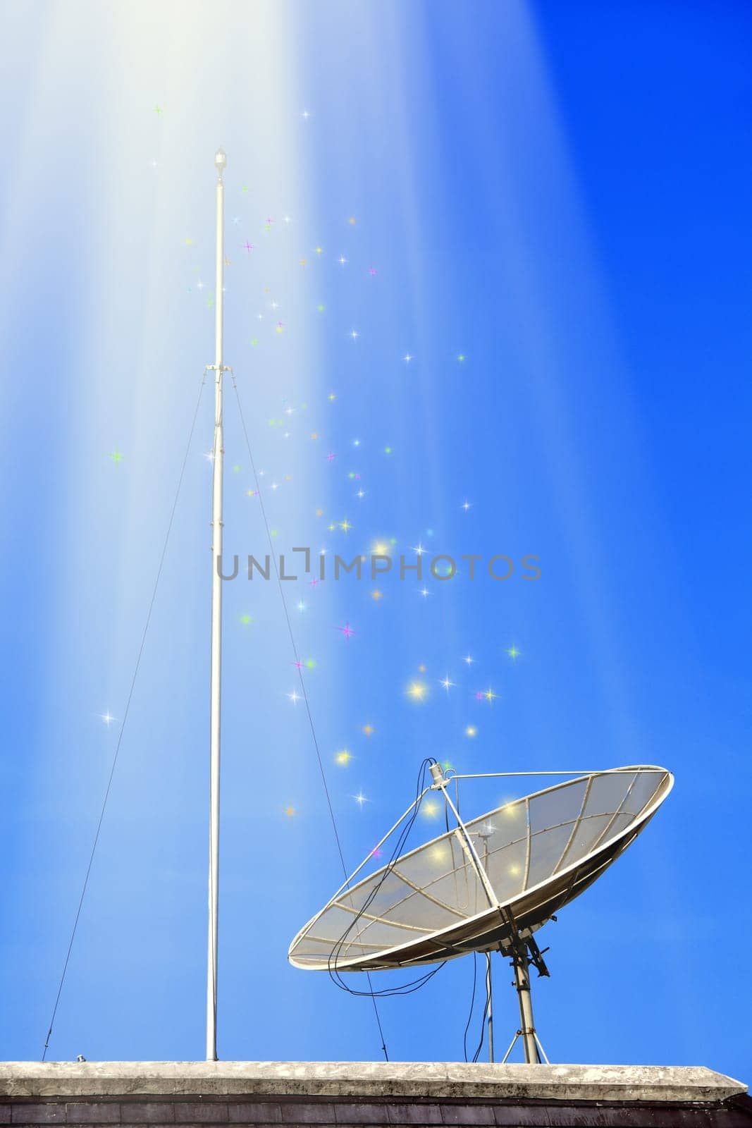 Conceptual image of a satellite dish antenna over night sky with abstract light manipulation