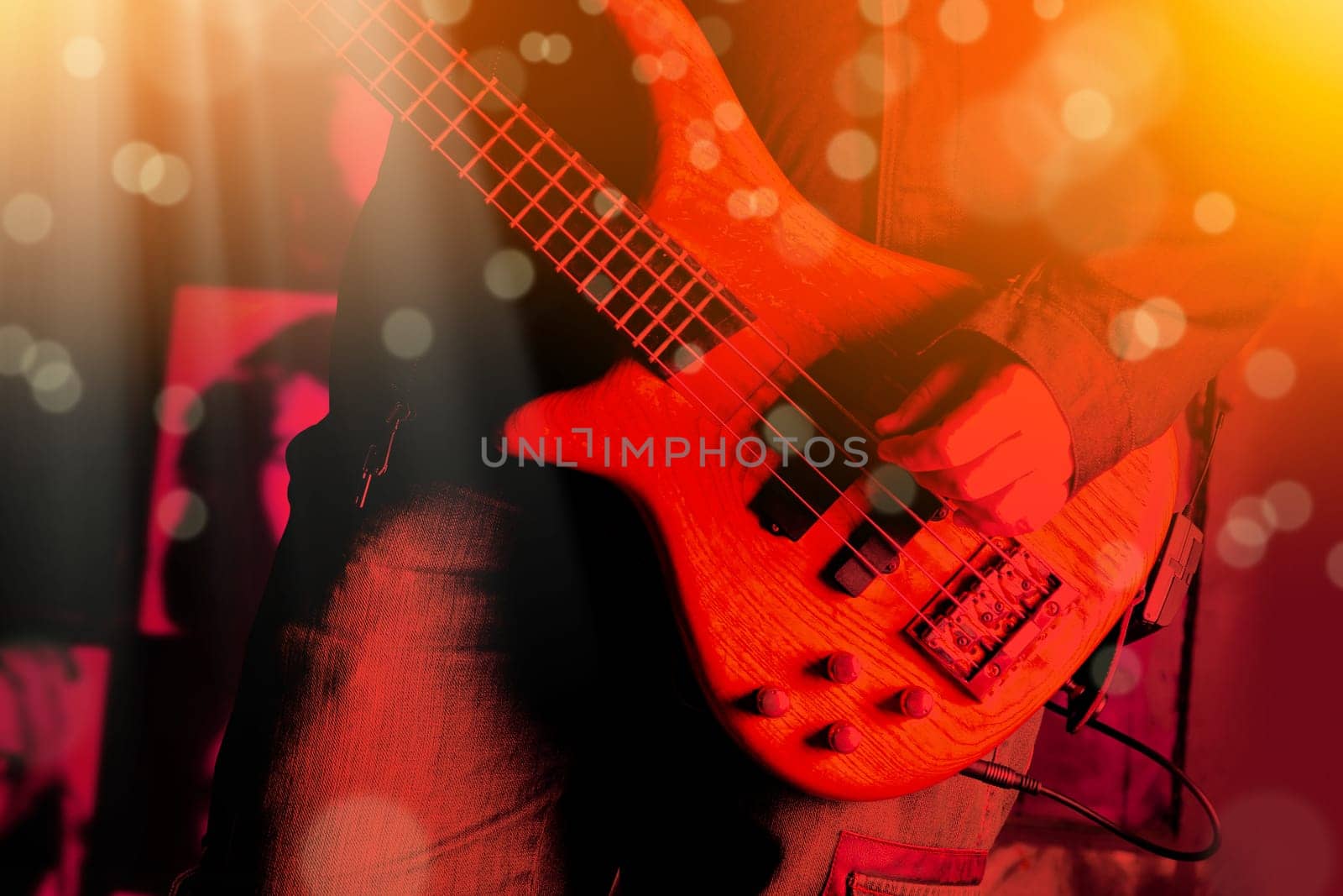 Life style image of close up young man hand, playing electric bass guitar