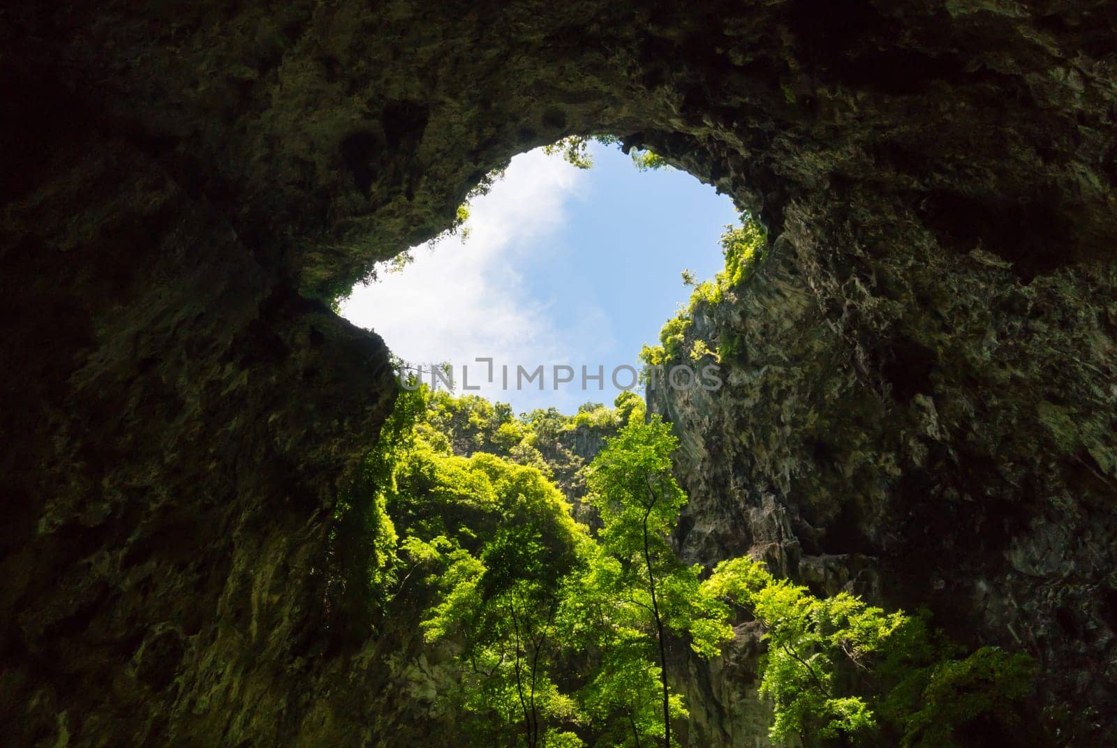 Sun light hole in Phraya Nakhon Cave with green tree and blue sky and cloud at Prachuap Khiri Khan Thailand. Natural cave in unseen Thailand