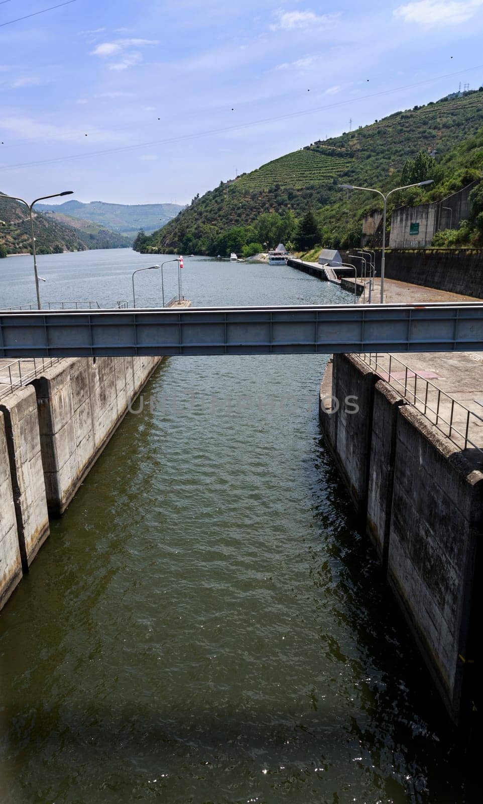View of the canal connecting the lock to the upstream of the Douro River on the Regua Dam, also called Bagauste Dam, Portugal