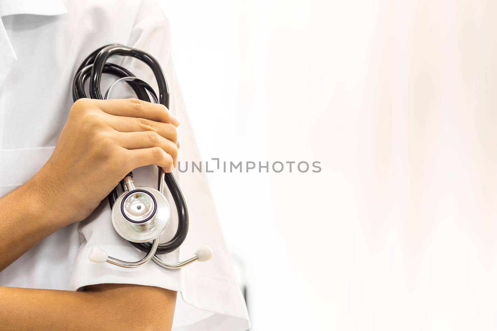 Female Doctor holding stethoscope with copyspace