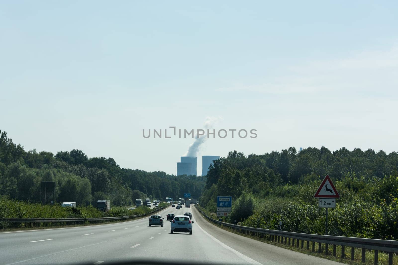 UNNA, GERMANY - AUGUST 23, 2017: Traffic on the A2 motorway and Scholven coal power station, Germany, North Rhine-Westphalia.
