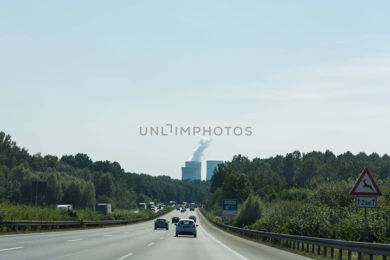UNNA, GERMANY - AUGUST 23, 2017: Traffic on the A2 motorway and Scholven coal power station, Germany, North Rhine-Westphalia.
