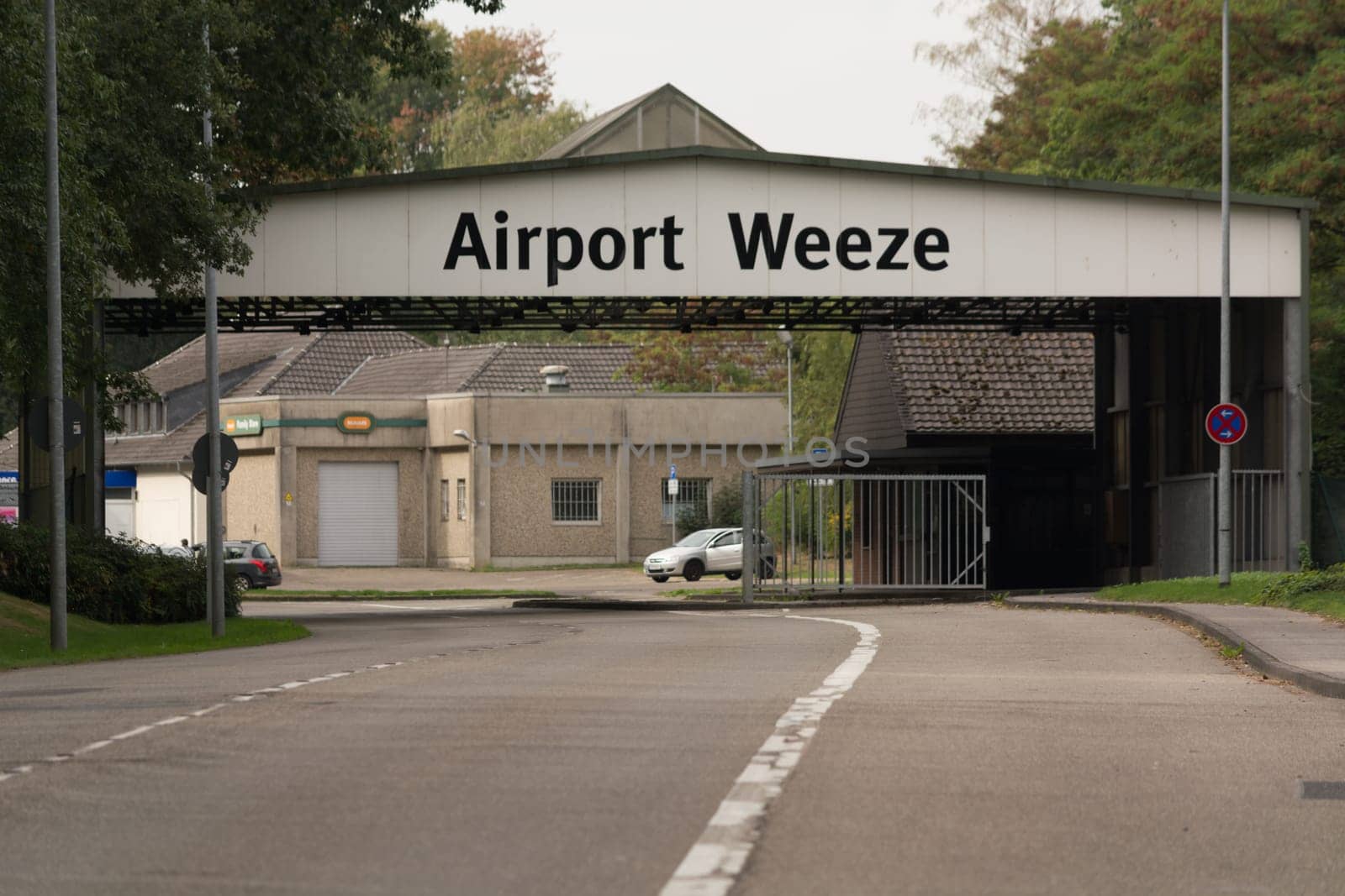 WEEZE, NRW, GERMANY - SEPTEMBER 10, 2018:.Militärisch ausehende Zufahrt zum Flughafengelände Weeze mit alten Kasernengebäuden ..WEEZE, NRW, GERMANY - SEPTEMBER 10, 2018:.Military outward access to Weeze Airport with old barracks buildings
