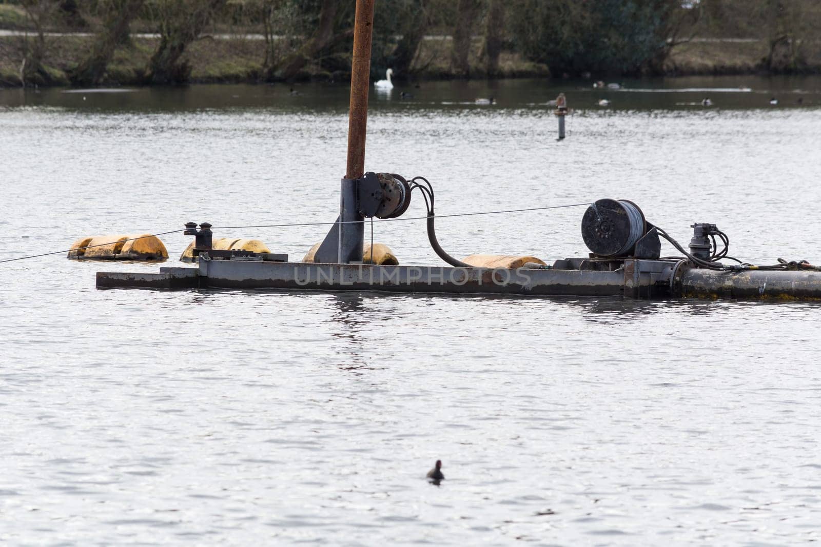 HEILIGENHAUS, NRW, DEUTSCHLAND - MÄRZ 03, 2017:.Special ship, working platform in use on a small pond. Wet dredging at the Abtskuecher Teich in Heiligenhaus.