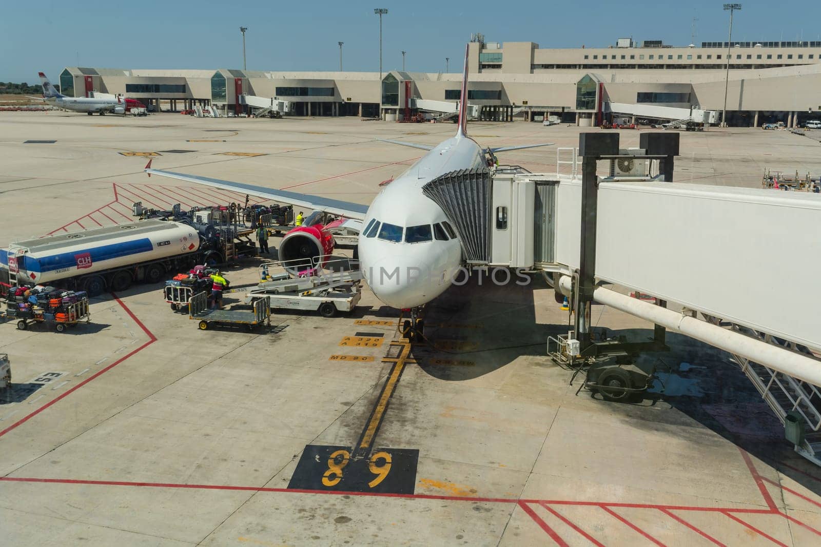 PALMA DE MALLORCA, BALEARIAN, SPAIN - JUNE 06, 2016: Airport of Mallorca, airplane in departure area during loading and refueling ready for departure.