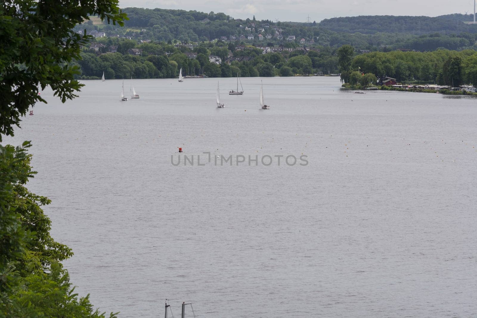 ESSEN, NRW, GERMANY - JUNE 10, 2017:.Panoramic view from Baldeney Lake (Baldeneysee). In the background sailing boats at a sailing regatta..