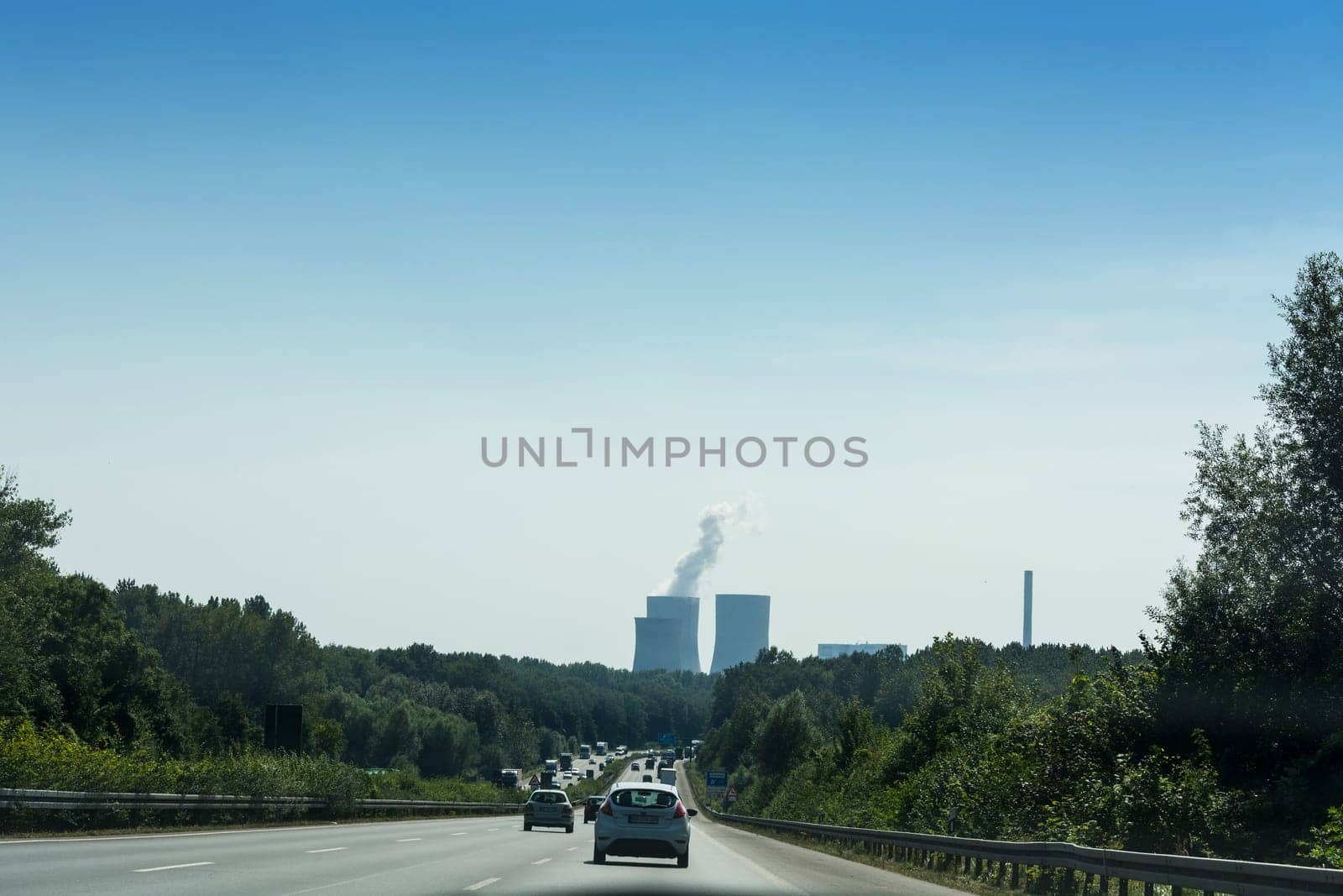 UNNA, GERMANY - AUGUST 23, 2017: Traffic on the A2 motorway and Scholven coal power station, Germany, North Rhine-Westphalia.