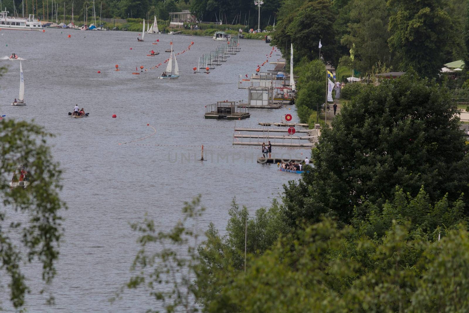 ESSEN, NRW, GERMANY - JUNE 10, 2017:.View of Lake Baldeney (Baldeneysee) in Germany. Right in the image Seaside Beach Baldeney. In the background sailing boats at a sailing regatta..