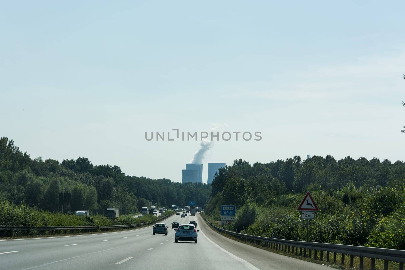 UNNA, GERMANY - AUGUST 23, 2017: Traffic on the A2 motorway and Scholven coal power station, Germany, North Rhine-Westphalia.