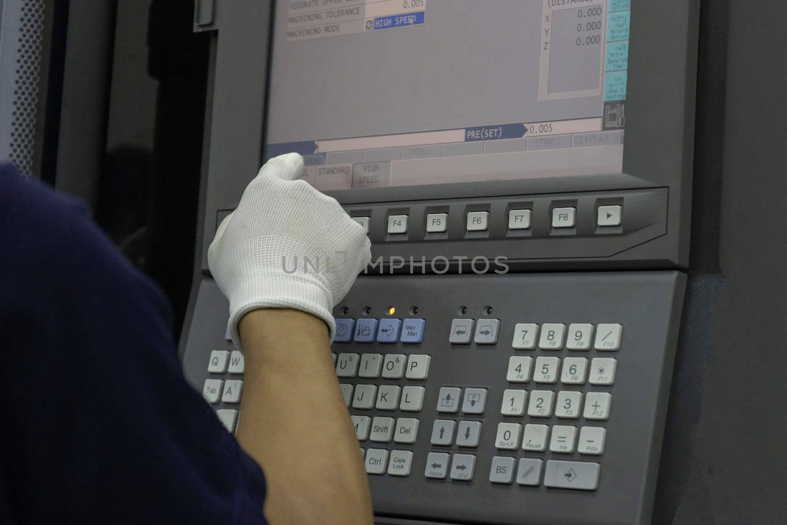 Man input data on cnc machine panel control