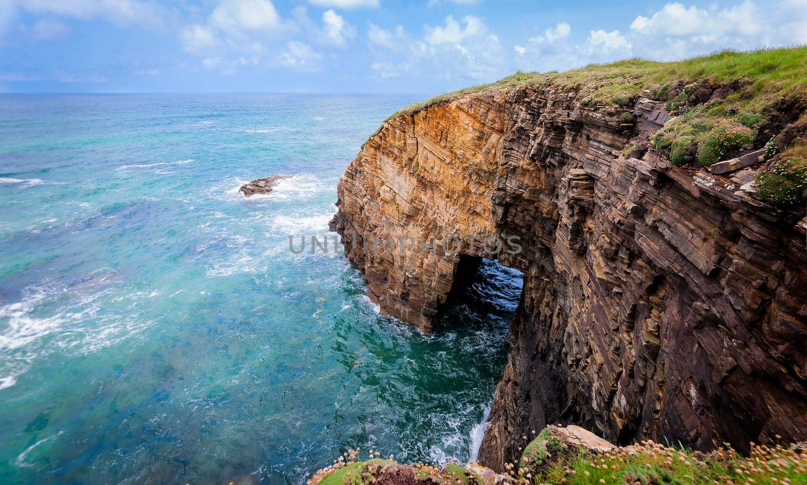 Landscape of sea, cliff blue sky with clouds. Ocean coast in the north west of Spain, Galicia region. Touristic travel.